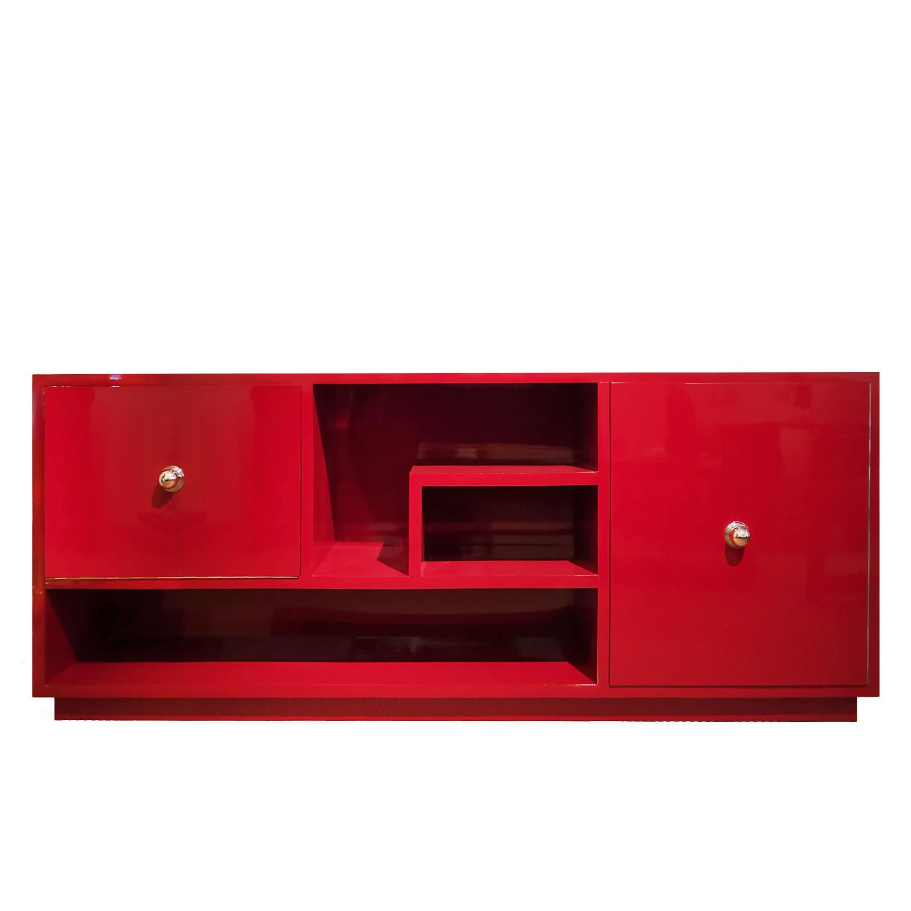 Low cubist sideboard, Chinese red lacquered wood, one flap door with bar inside, light on the left side. One door with two shelves. Mahogany veneer inside. Chrome plated brass handles.

Design: GATCPAC Mouvement.

Spain, Barcelona circa 1930.