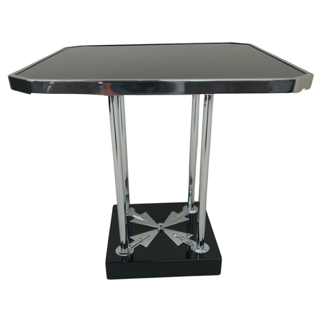 One of a kind Bauhaus Art Deco side table. Unique design with a black glass top, four chrome supports on a black lacquer base with chrome arrow accents. Table has been professionally restored. Dimensions 22 inches square by 22.5 inches high
