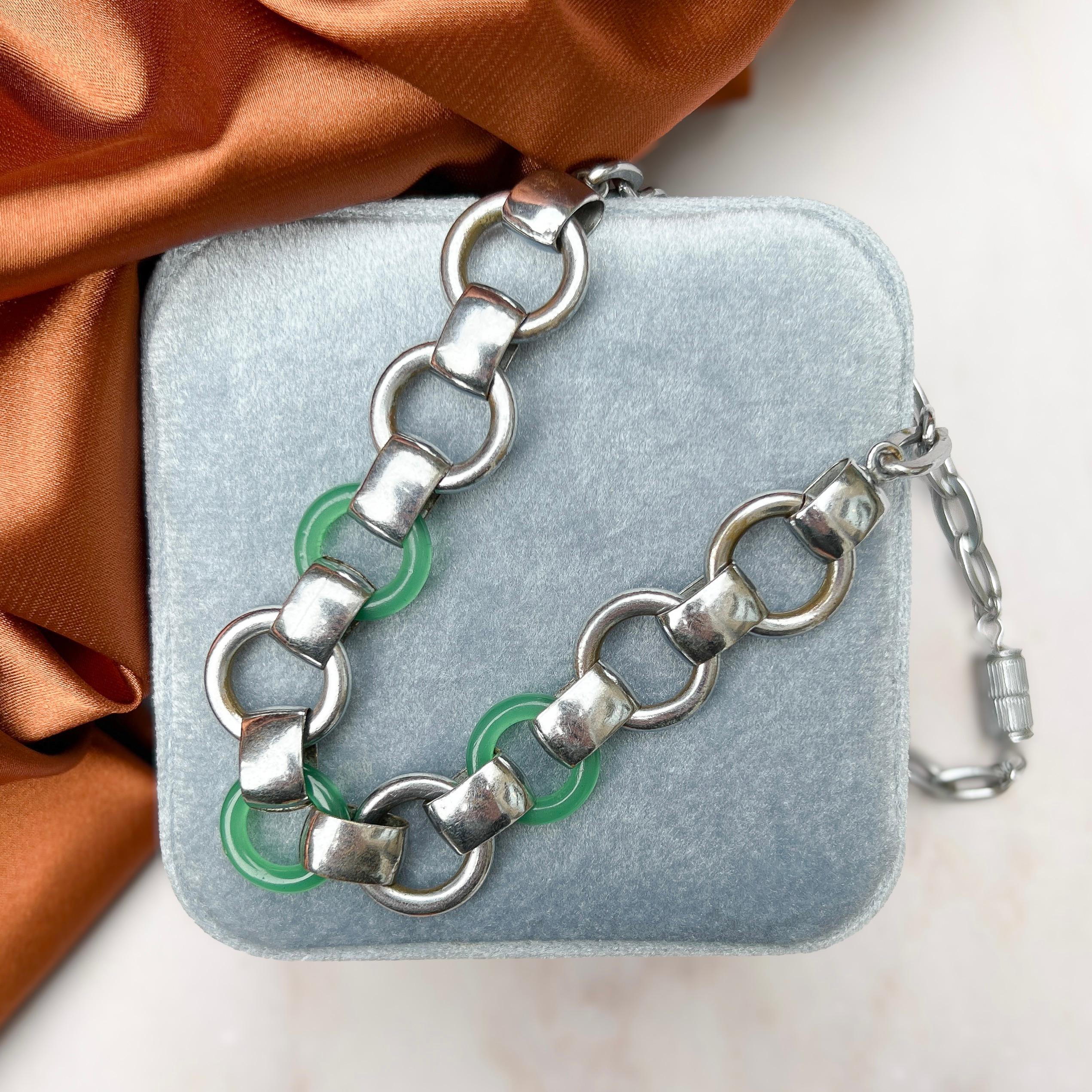 This stylish necklace dates from the 1930s and evokes the Machine Age aesthetic of the era. It was most likely made in Germany by the Jakob Bengel company. 

Condition Report:
Very Good - Some rubbing to the plating on the large loops of the