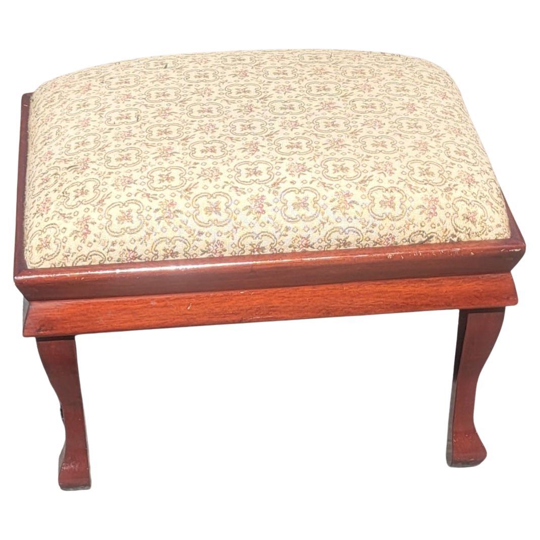 A charming 1930s vintage mahogany upholstered footstool. 
Measures 20