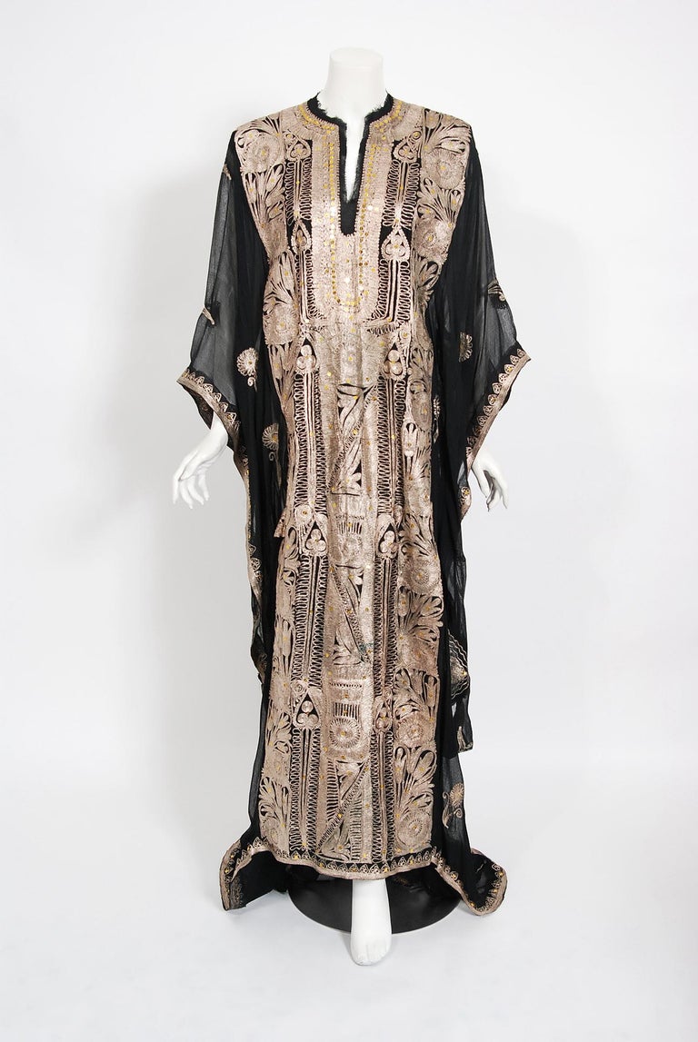 A sensational 1930's museum-quality treasure! With its metallic gold sparkle and breathtaking silhouette, this rare garment makes a memorable impression. The workmanship on the elegant semi-sheer silk chiffon is unbelievable; the brilliant metallic