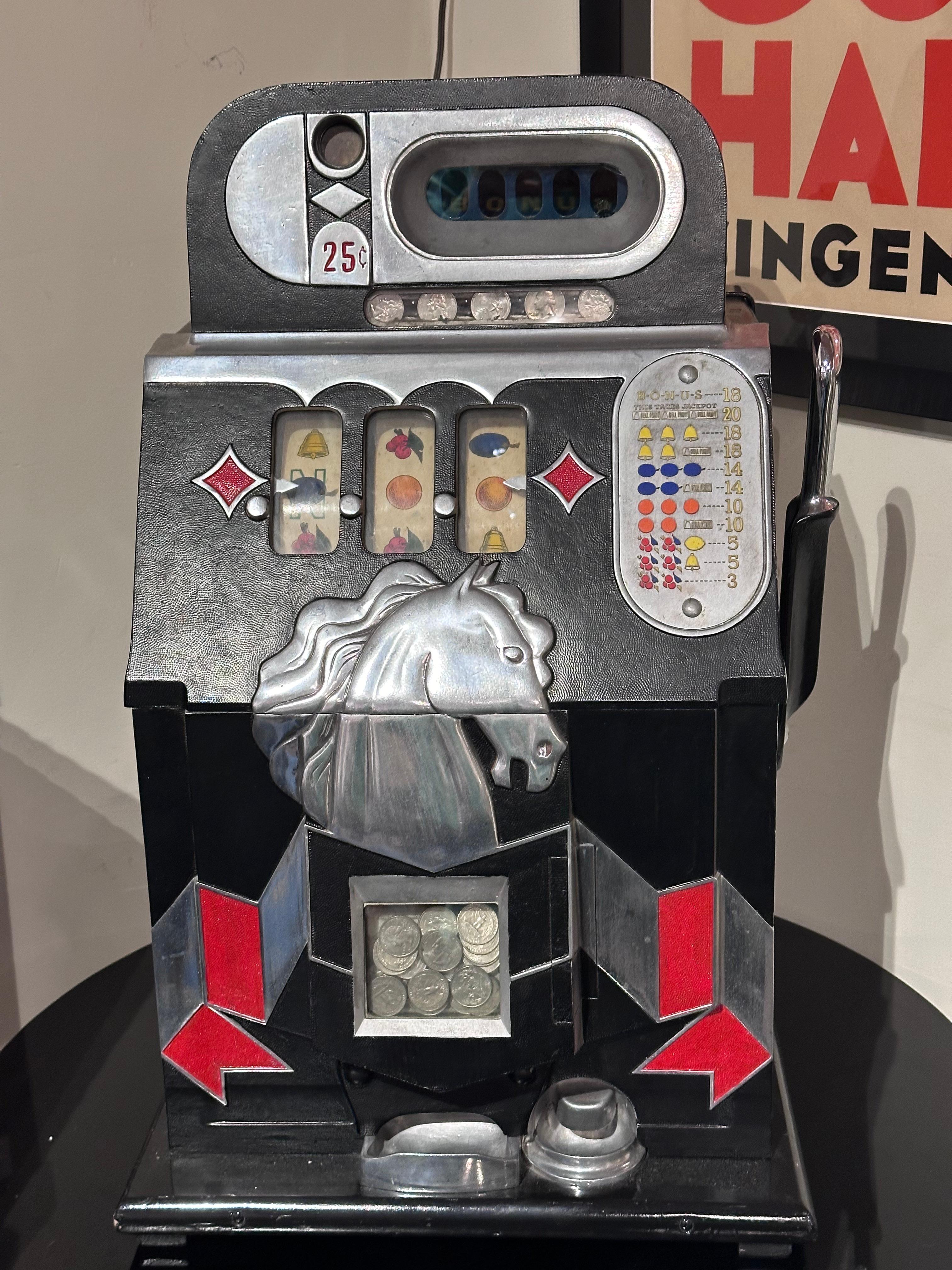 This 25-cent Mills Novelty Horsehead Slot Machine from around 1937, produced by the Mills Novelty Company in Chicago, Illinois, is a charming relic of the Art Deco era. Despite showing signs of use and age, it remains in very good original condition