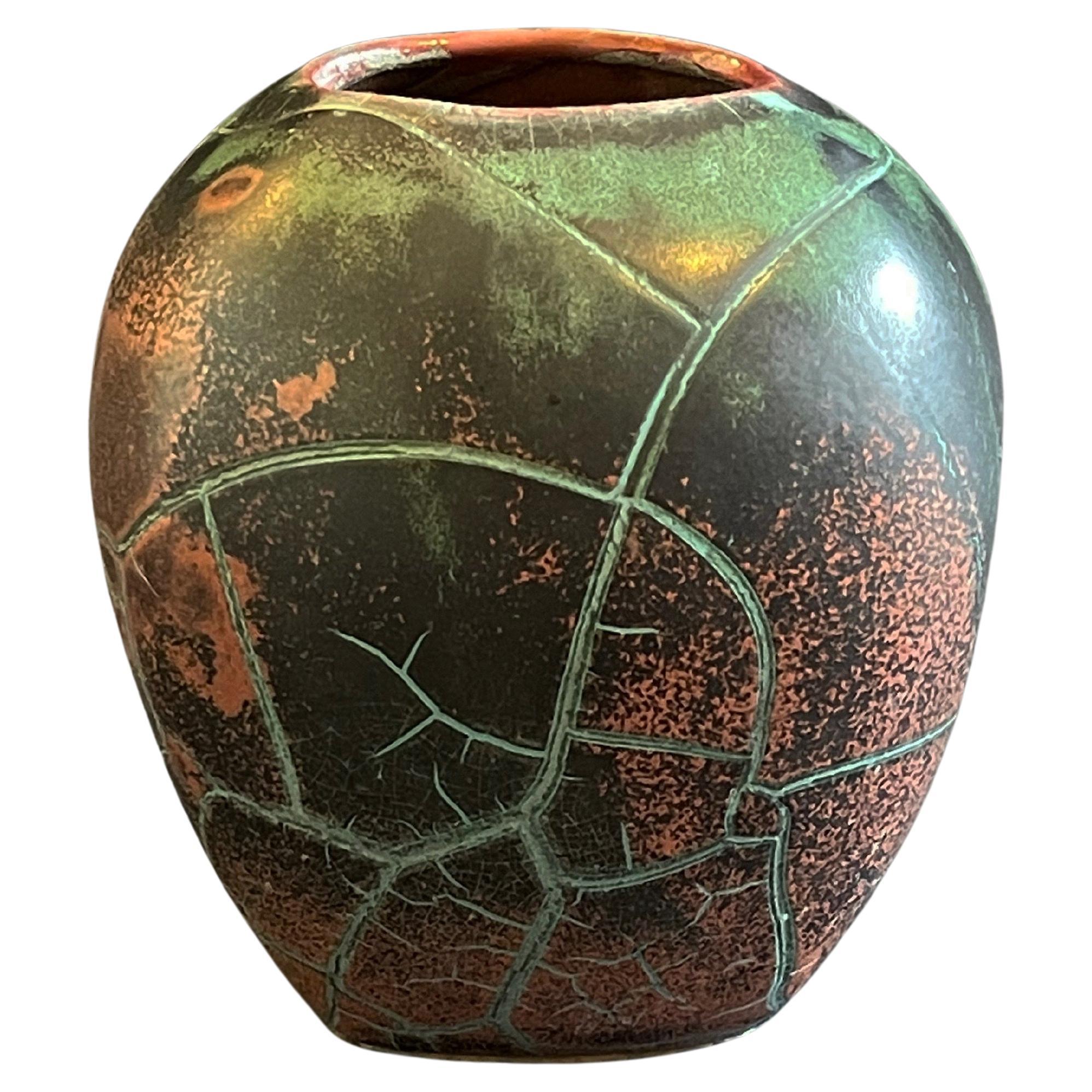 Impressive and one-of-a-kind vase by Paul Dresler, Grootenburg Keramik.
Each piece is unique, here with a lava-like Chinese style reduction glaze: 
colours of a dark turquoise, burnt reds with veins of lighter colours giving an asian touch to the