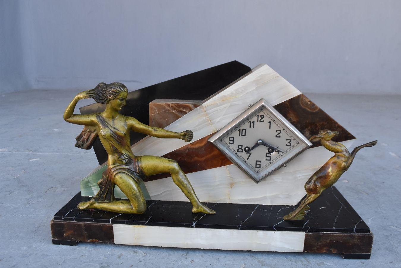 1930s modernist Art Deco mantel clock in onyx. Hunter and antelope on the front.