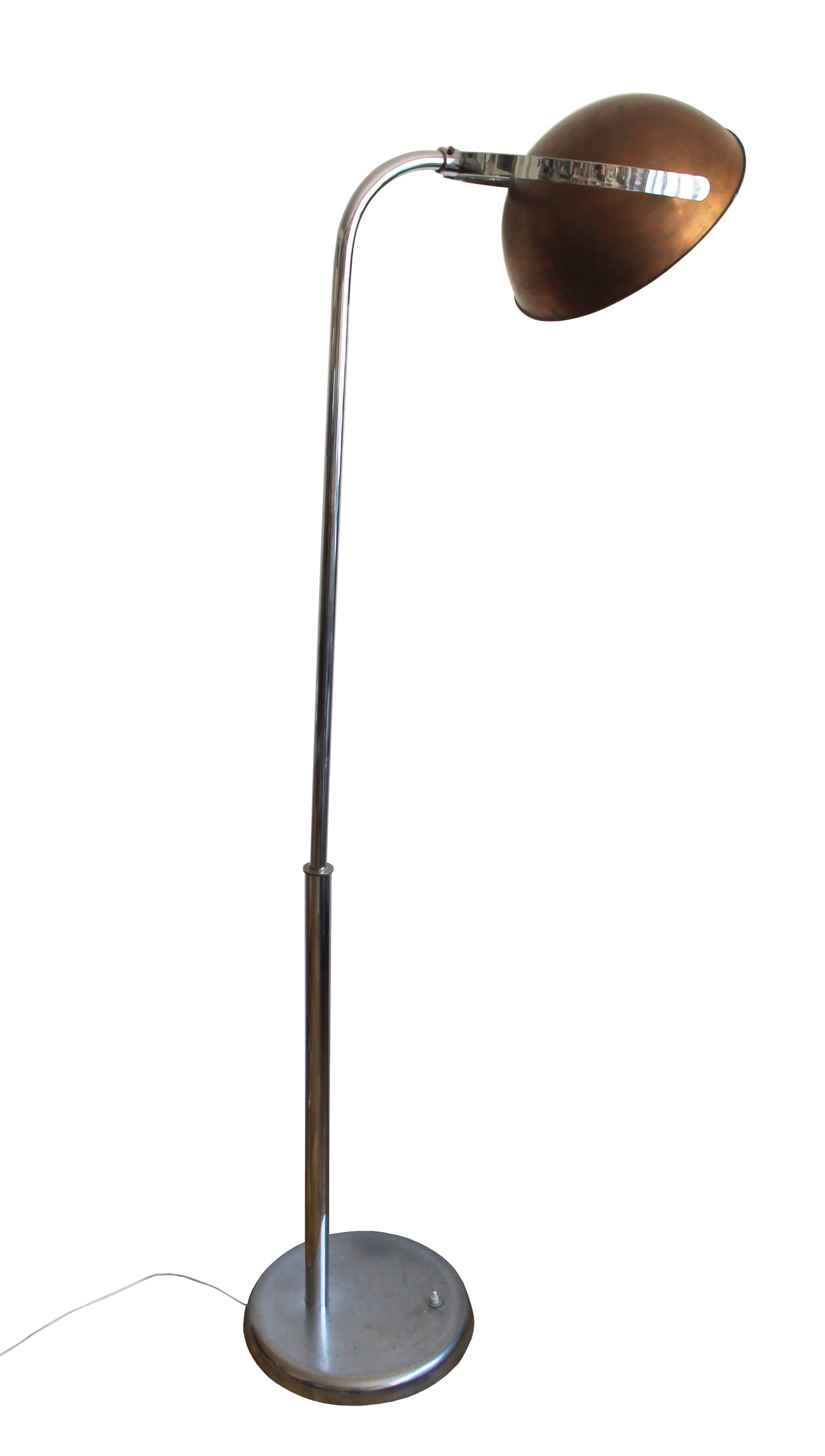 This is an original piece made in 1930’s Czechoslovakia. A striking dominant floor lamp, with super sized proportions. A large copper headlight that is adjustable, supported by a stainless steel up-stand, this piece is unusually striking. Used as a
