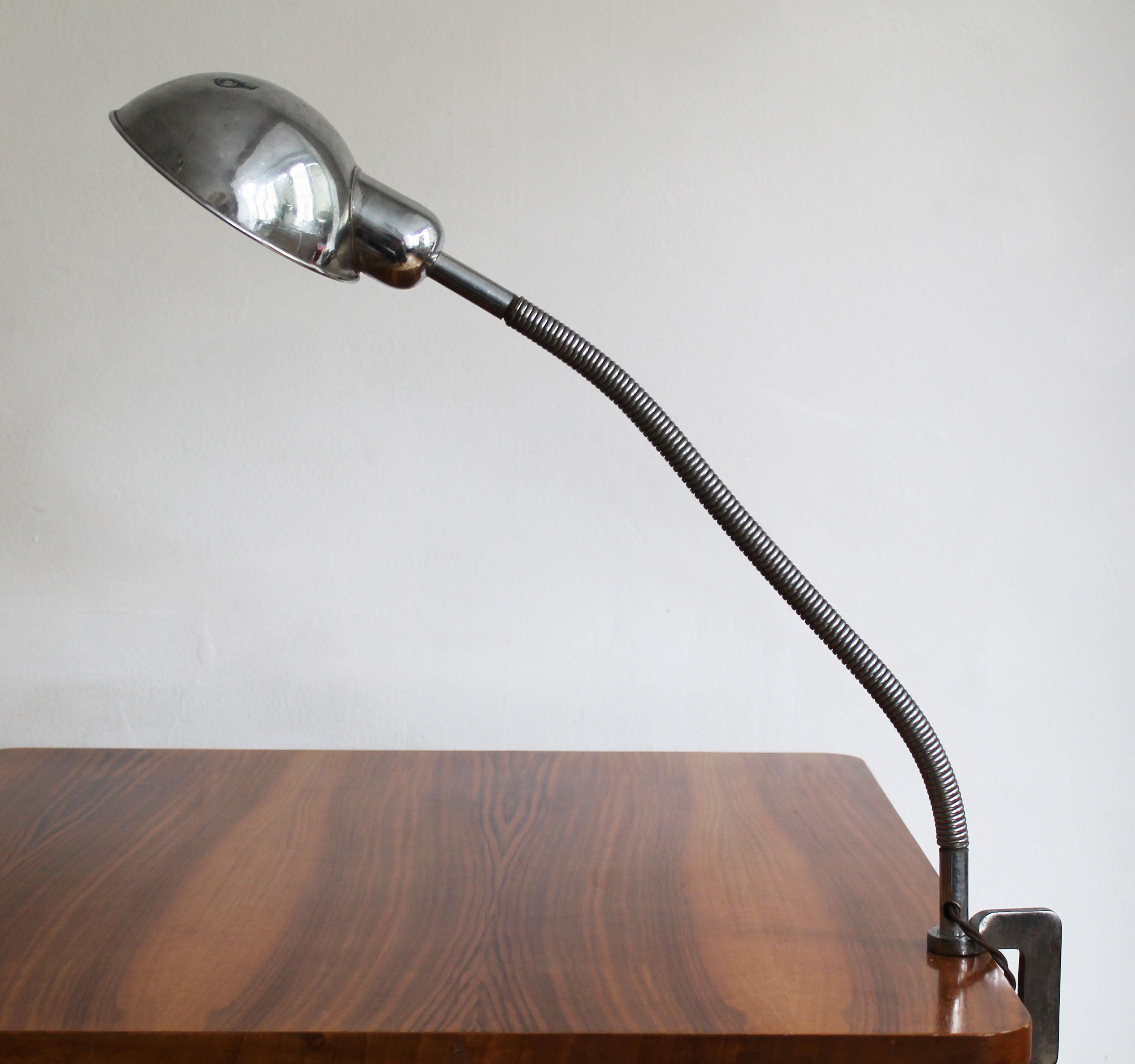 This is an original 1930’s office/workshop desk lamp. Due to its design, it is often nicknamed the “gooseneck”. This piece can be fixed directly to the desk (of varying thicknesses) and the lampshade can be adjusted up or down and also to the sides.