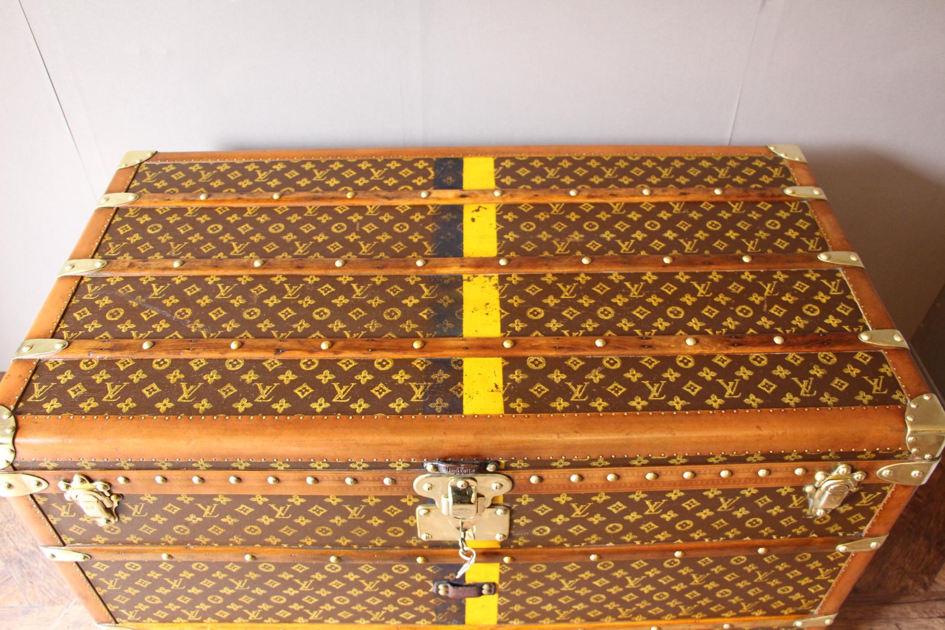 This beautiful Louis Vuitton trunk is all stenciled LV monogram canvas, with all Louis Vuitton stamped brass hardware and lozine trim. It features large leather side handles as well as customized painted yellow and blue stripes and MGM initials on