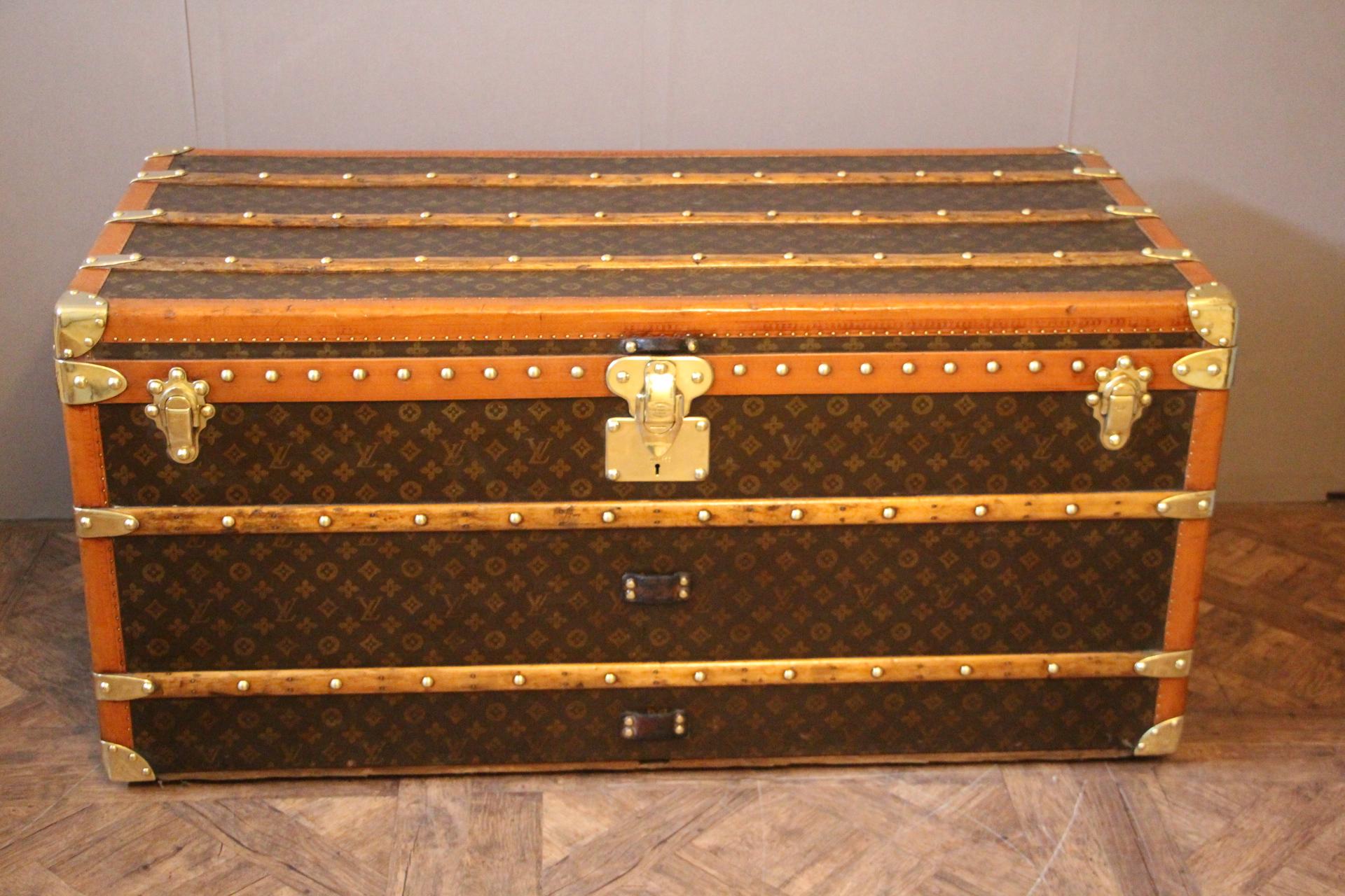 This beautiful Louis Vuitton trunk is all stenciled LV monogram canvas, with all Louis Vuitton stamped brass hardware and lozine trim. It features large leather side handles as well as a customized French flag on each side. It has got a very warm