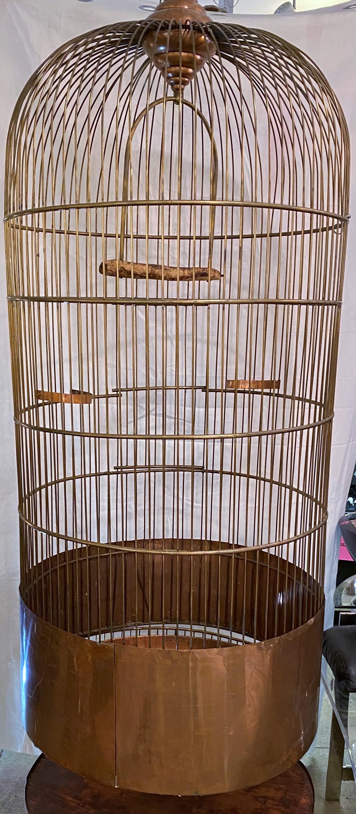 1930s monumental copper bird cage with copper stand

cage is 65 inches high
stand is 13.5 inches high 
full diameter for both is 31 inches.