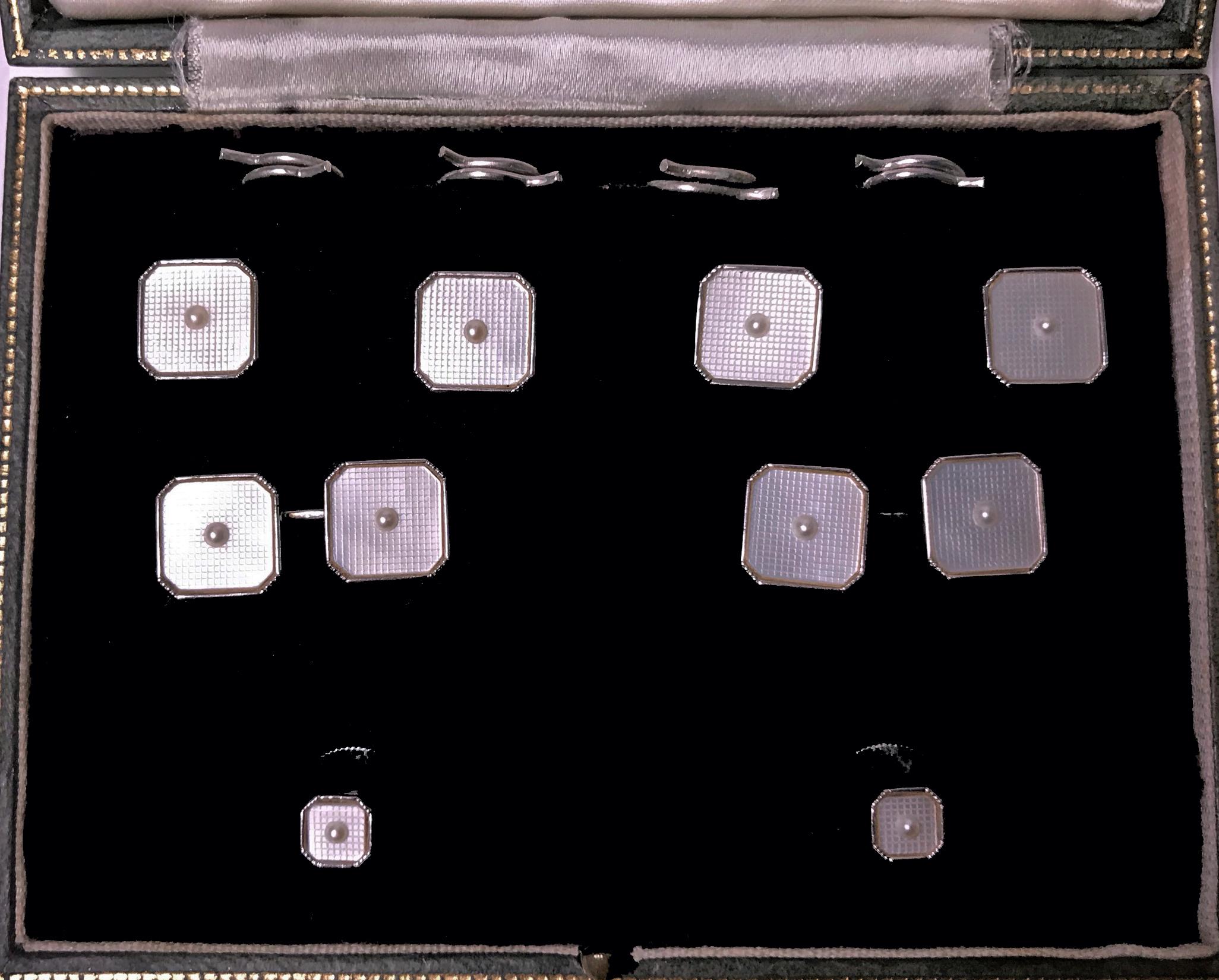 Mother of Pearl, Pearl and White Gold Tuxedo Cufflinks Dress Set, English, C.1930. The set comprising pair of Cufflinks, four buttons and pair of collar studs. Each square shape centering a small pearl on engine turned design mother of pearl,