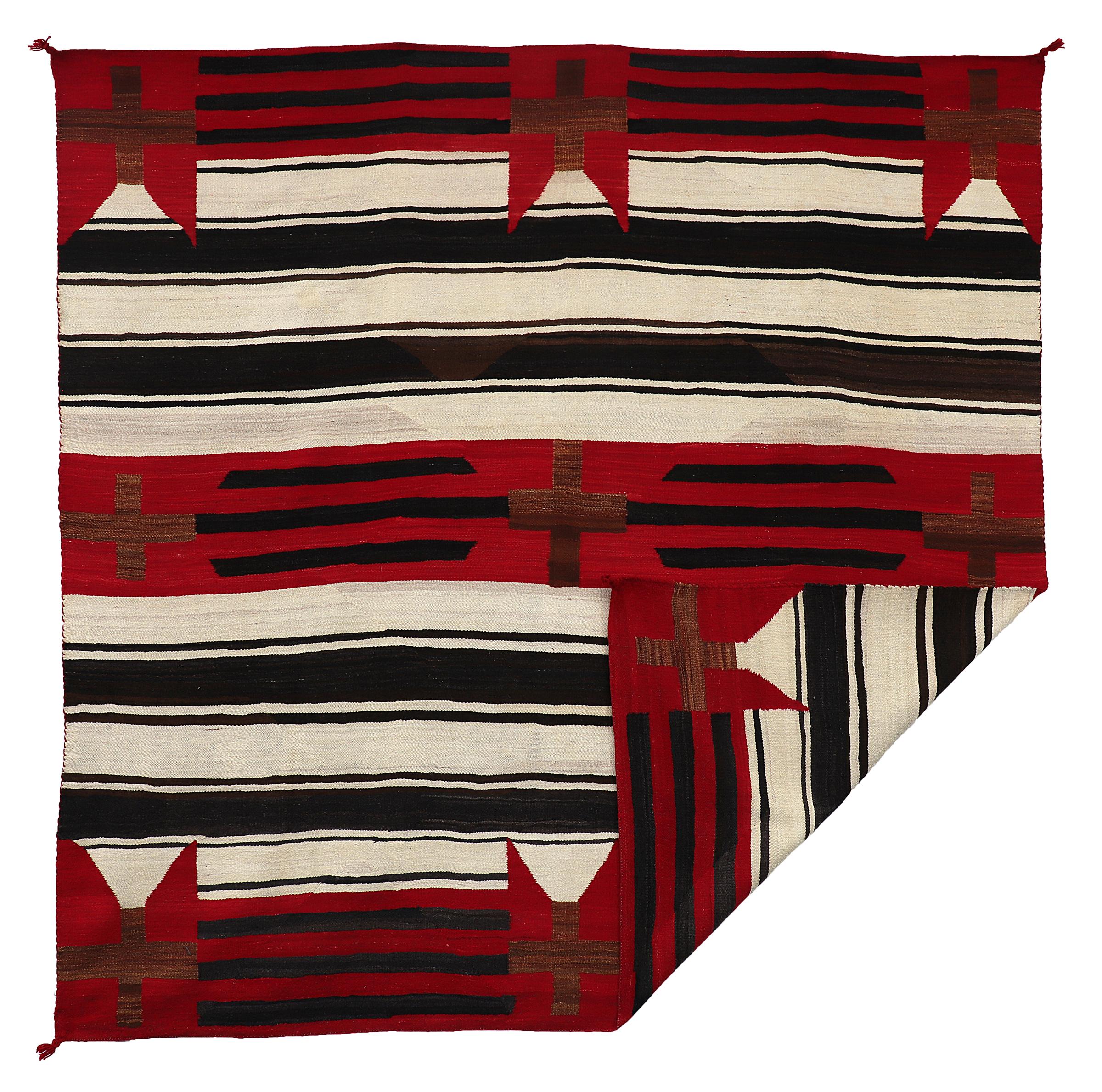 Vintage 1930s Navajo Trading Post era Chiefs Blanket in a unique variant pattern with crosses and a classic banded background. Woven of native handspun wool in natural fleece colors of white/ivory, Brown and black with aniline dyed red.
This