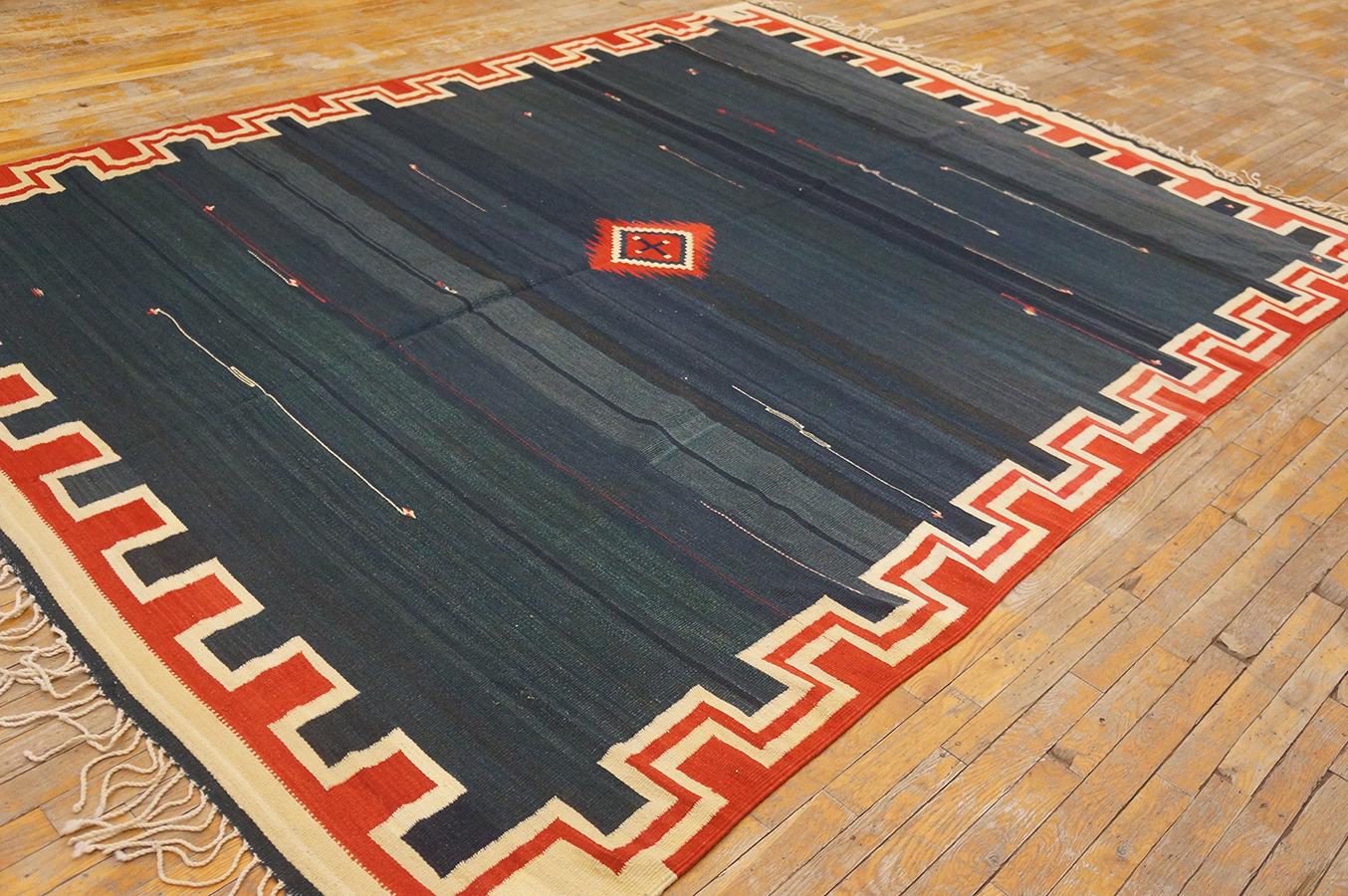 This shared-warp, flat tapestry woven piece is extremely rare both for its large size and for its much abrashed rich dark blue ground highlighted by streaking white “shooting stars”. The small central red. Ivory and black diamond is tonally matched