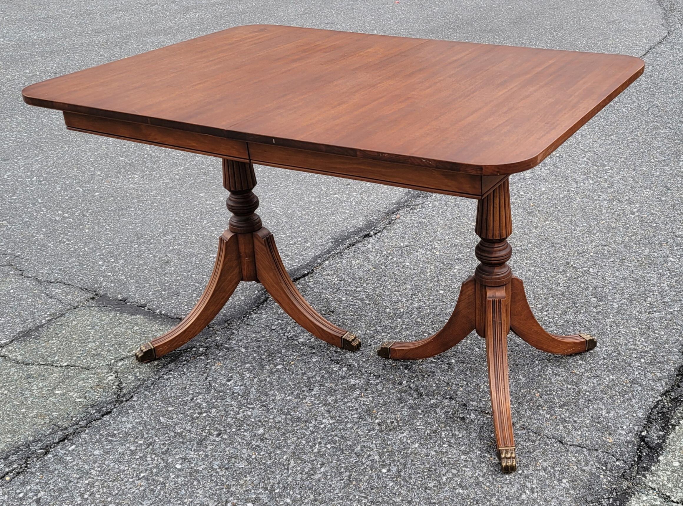 1930s Newly Refinished George III style Double Pedestal Mahogany Extension Dining Table. Excellent condition. Totally refinished to the pedestals and legs with hand-rub finish appearance. Measures 59.5