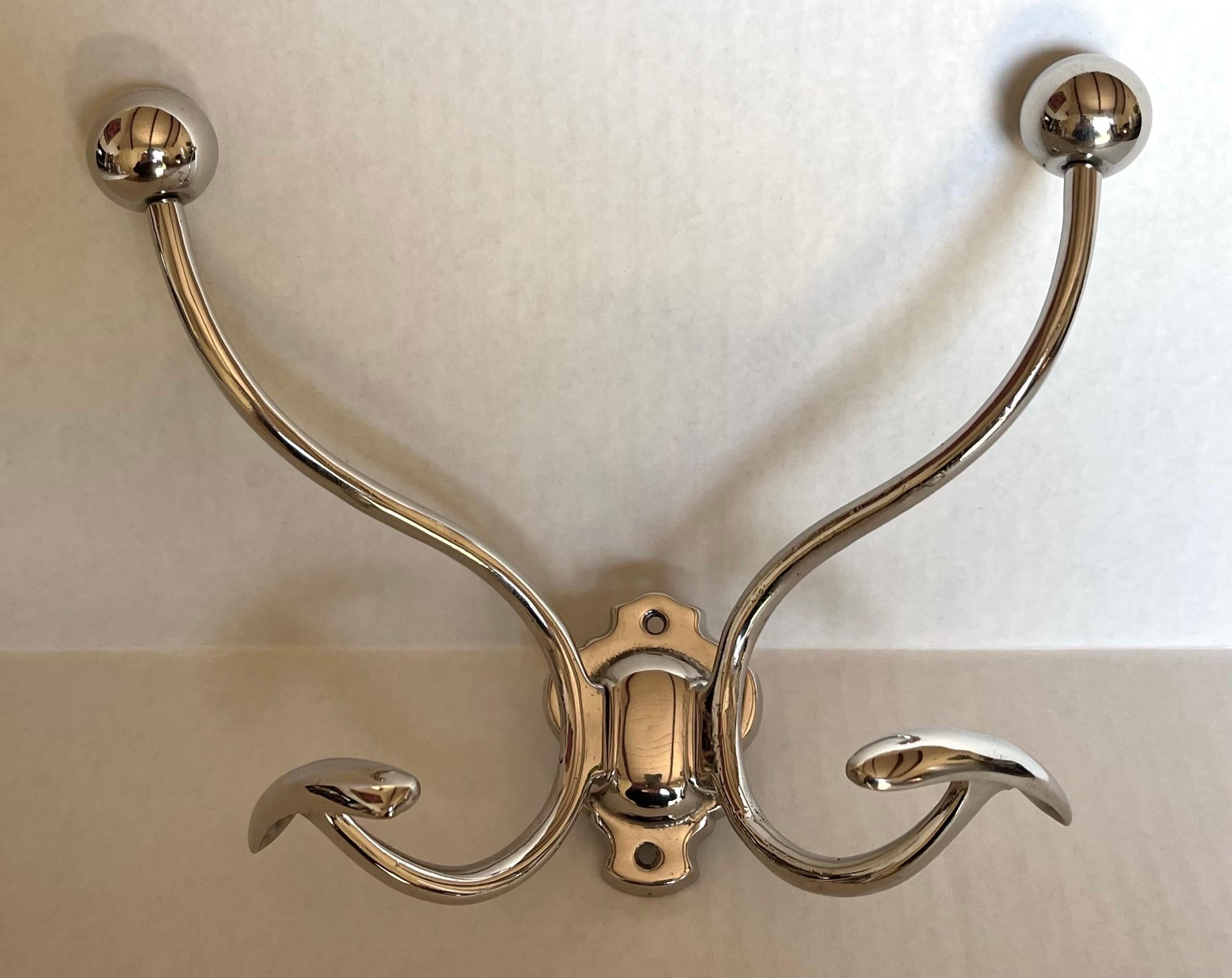 1930s nickel two-arm coat or towel hook. Newly professionally polished to a high shine. 
Mounting hardware is not included.
