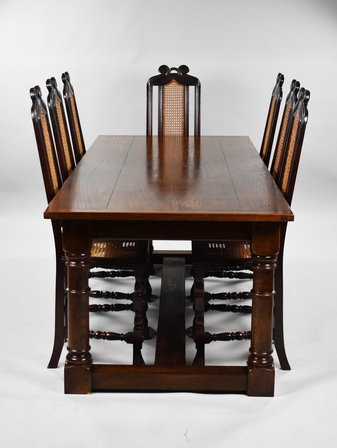 1930s Oak refectory table and eight single chairs in good condition. The chairs have cane weaved seats and backs with decorative top and spiral supports to each shaped leg.