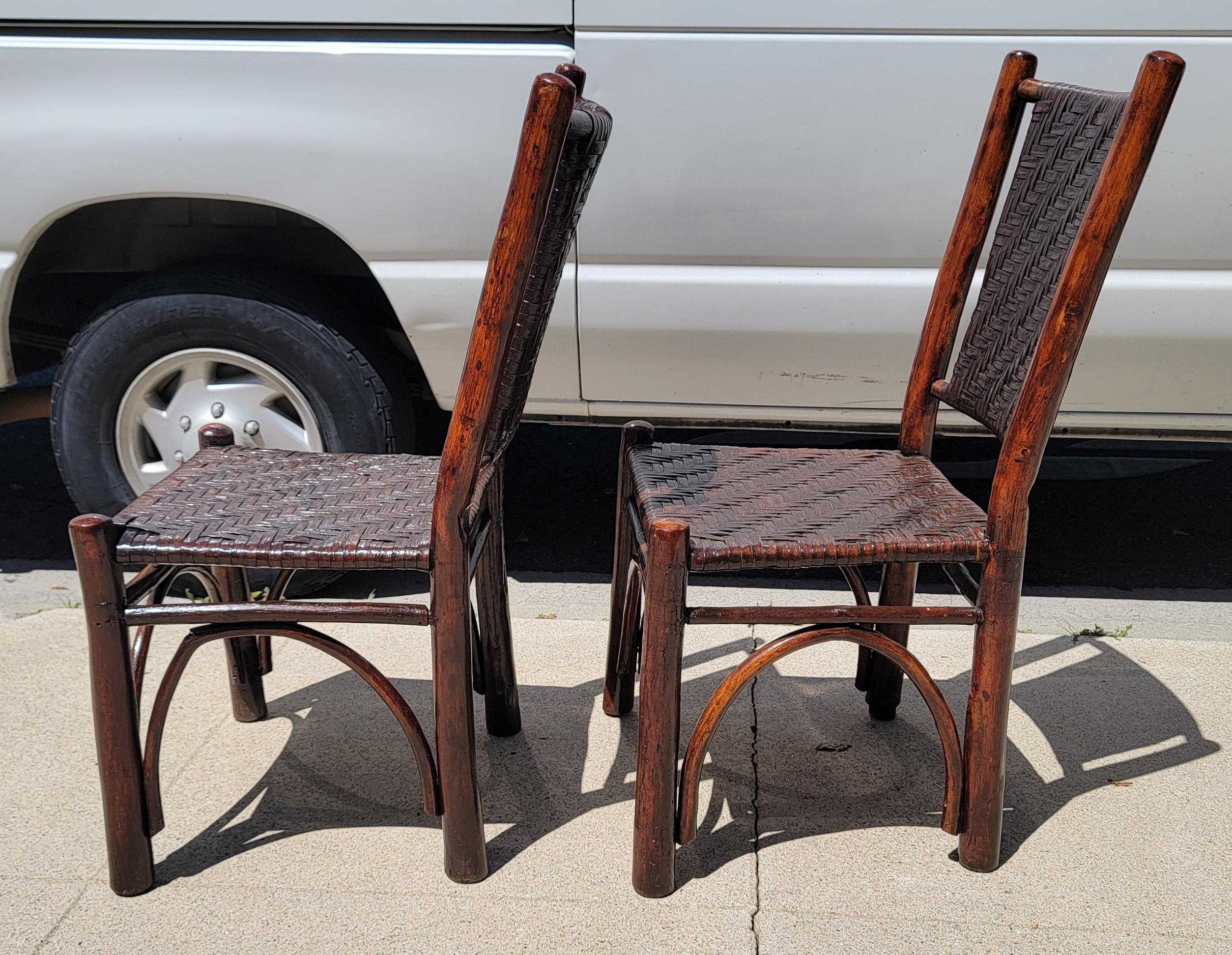 Pair of wonderful hickory chairs with rattan seating. 
Strong hickory hand made chairs. 
Strong design.