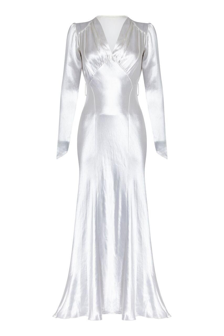 This enchanting 1930s silk satin wedding gown is in really good vintage condition and of exceptional quality. The opulent silvery white satin fabric is unlined and expertly tailored to create a flattering fairytale silhouette that would complement a