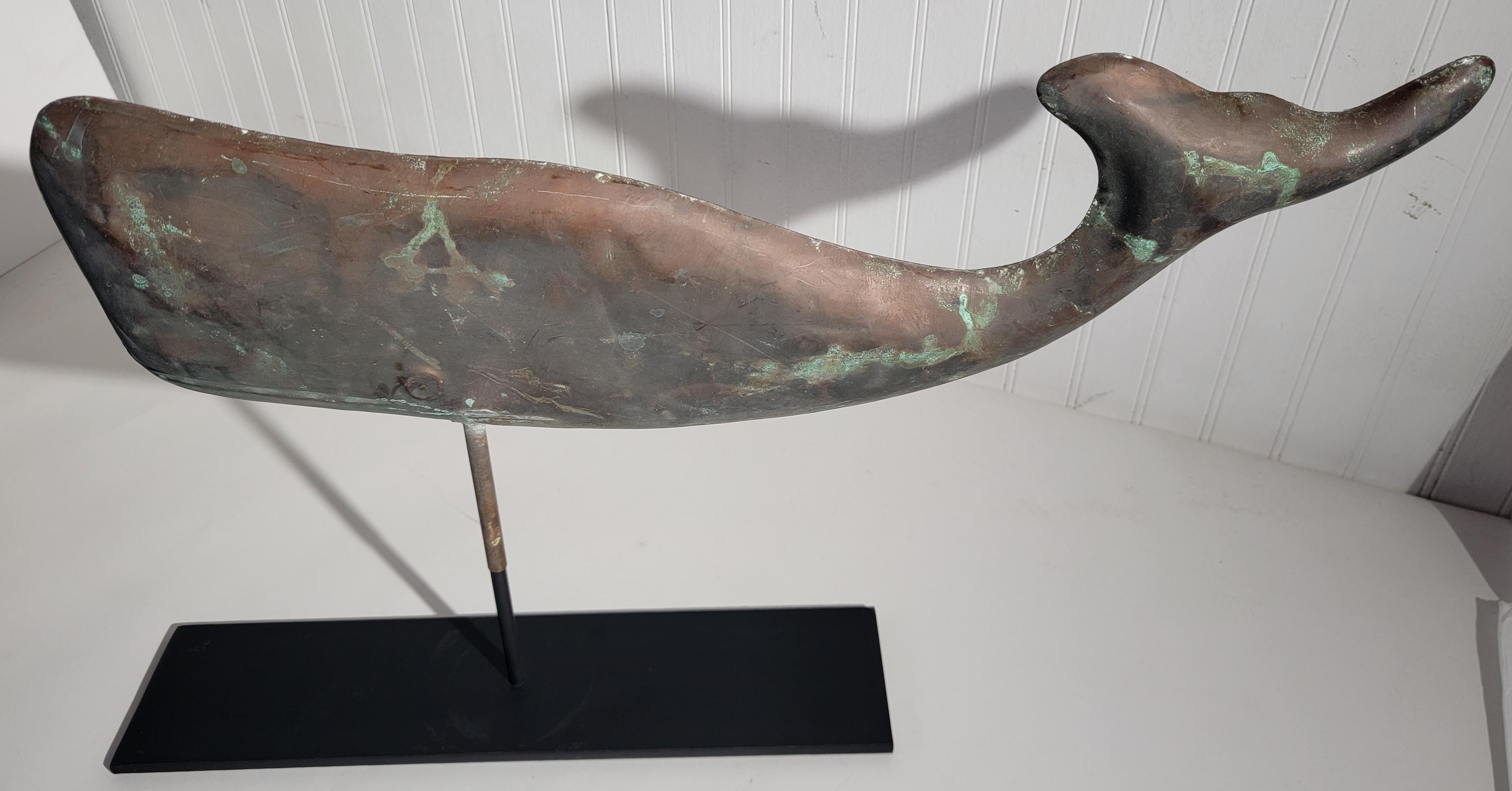 1930s oversized Copper whale weather vane with amazing copper patina. This weather vane is mounted on a custom handmade iron mount. Wonderful age and wear consistent of its time.
