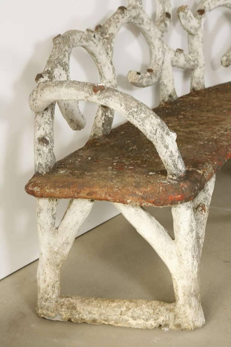 Faux bois garden bench and table made of molded and painted concrete made to look like trees. Bench features looped branches as back decoration.
Made in France, circa 1930.

Measures: Bench - 83” W x 45” H x 20 1/2” D x 19” SH. 
Table - 28”