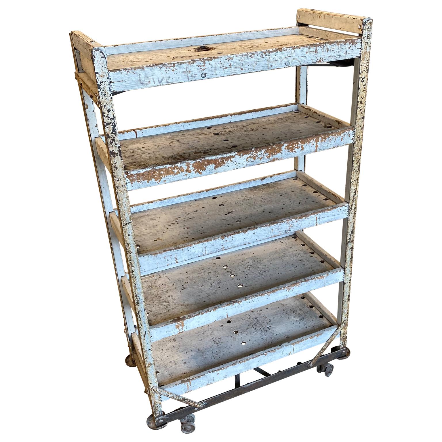 American 1930s white painted wooden rolling storage rack with 5 shelves

This Industrial mobile rack is very charming, especially with it's vintage painted finish.

 