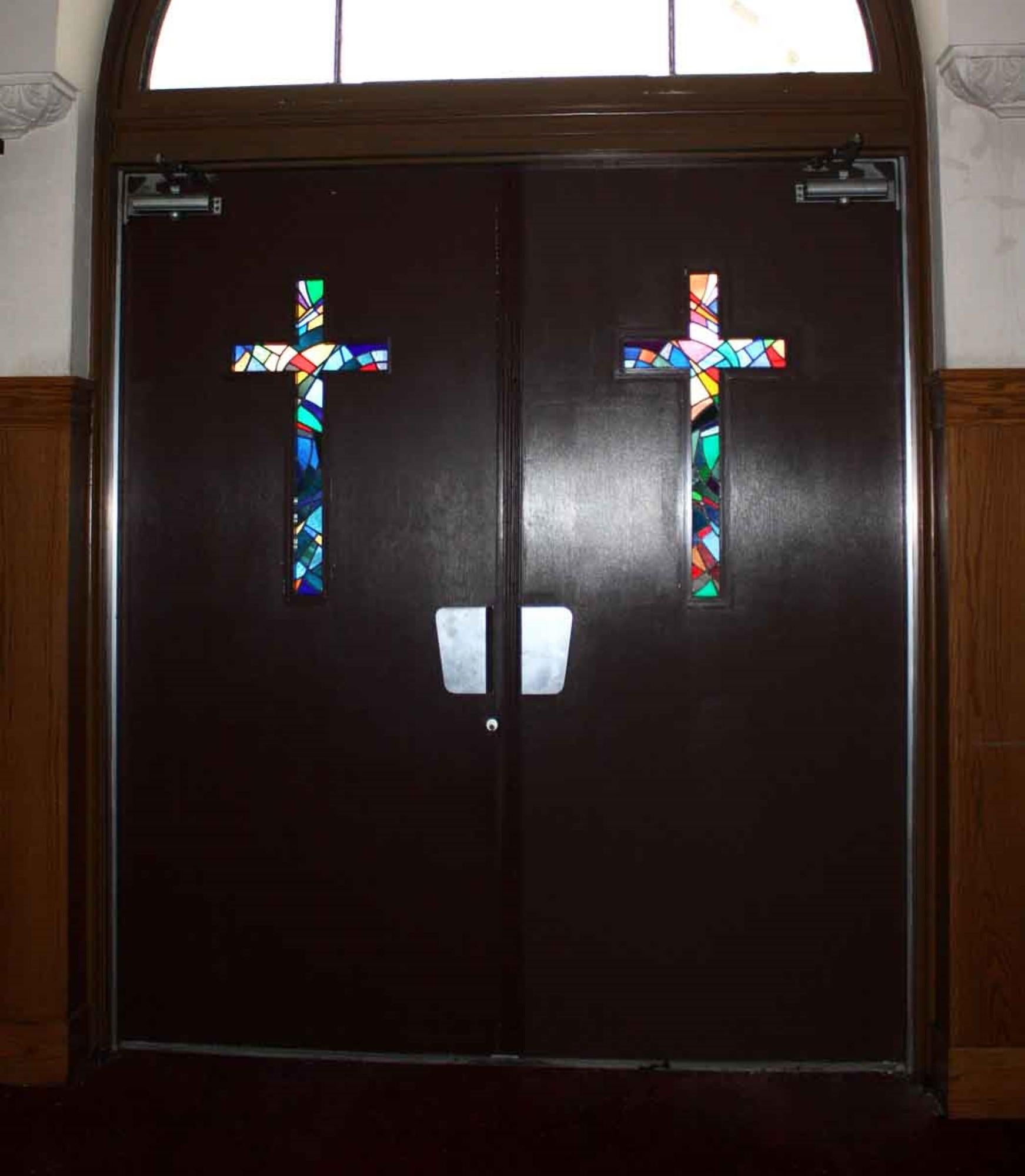 This 1930s pair of brilliantly colored stained glass doors are from a church built in the early 1900s. The doors are clad with ribbed aluminum and have the original Art Deco pulls. Small quantity available at time of posting. Priced each. Please