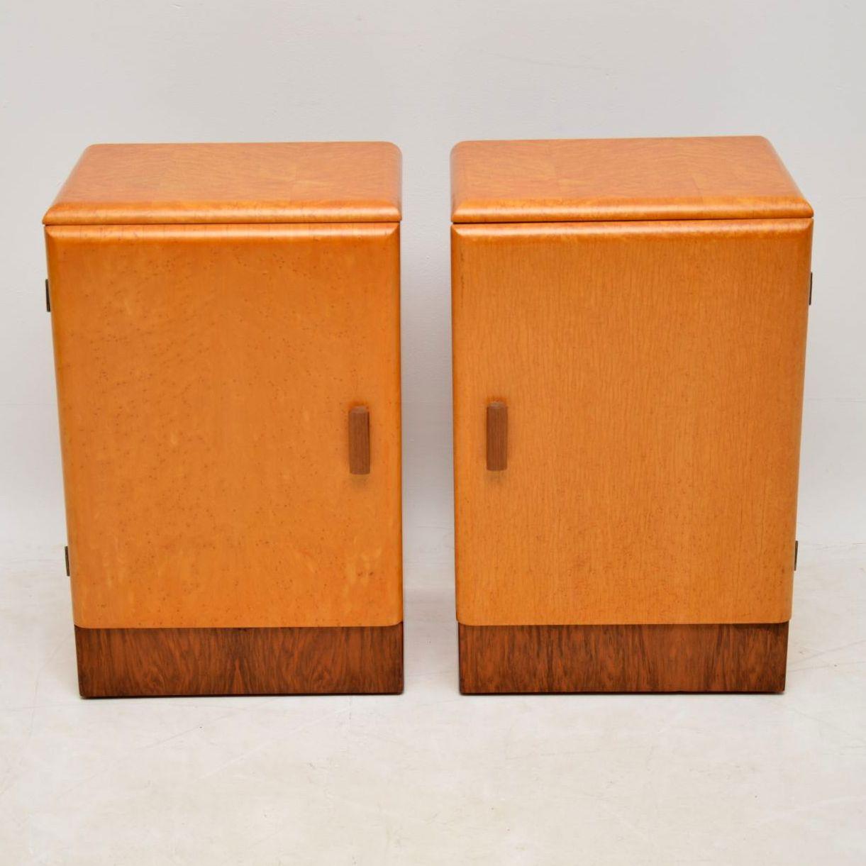 A stylish and well made pair of Art Deco bedside cabinets predominantly in bird's-eye maple, with walnut bases and handles, these date from circa 1930s-1950s. These are a great size, have a beautiful color and lovely grain patterns. We have had