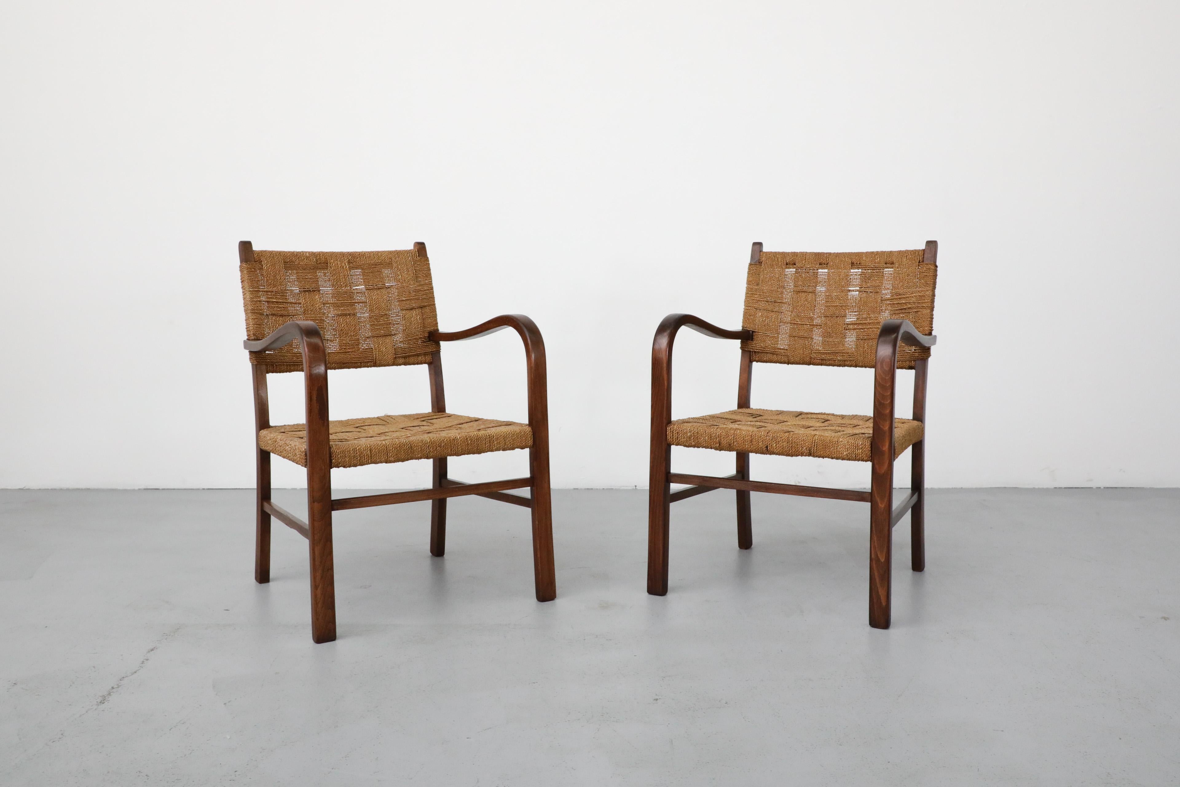 1930's Pair of hand-woven rope and wood armchairs by Swedish designer Axel Larsson for Svenska Möbelfabrikerna Bodafors. Bodafors made furniture for the affluent through the 1930s. However, a new goal of manufacturing reasonably priced furniture for