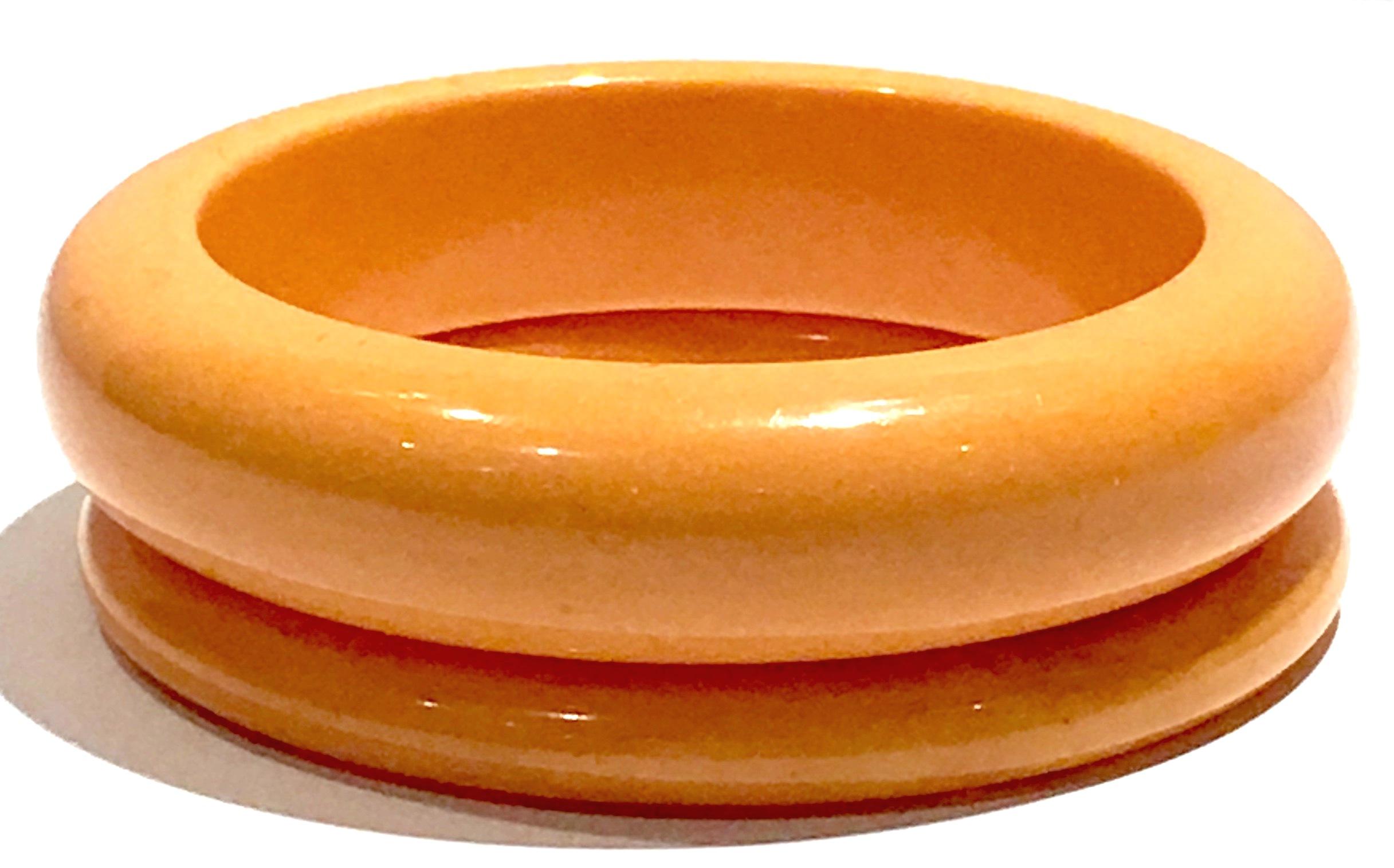 1930'S Art Deco Pair Of Bakelite Butterscotch Bangles. This pair of bangles features two sizes. The smaller bangle measures, .50