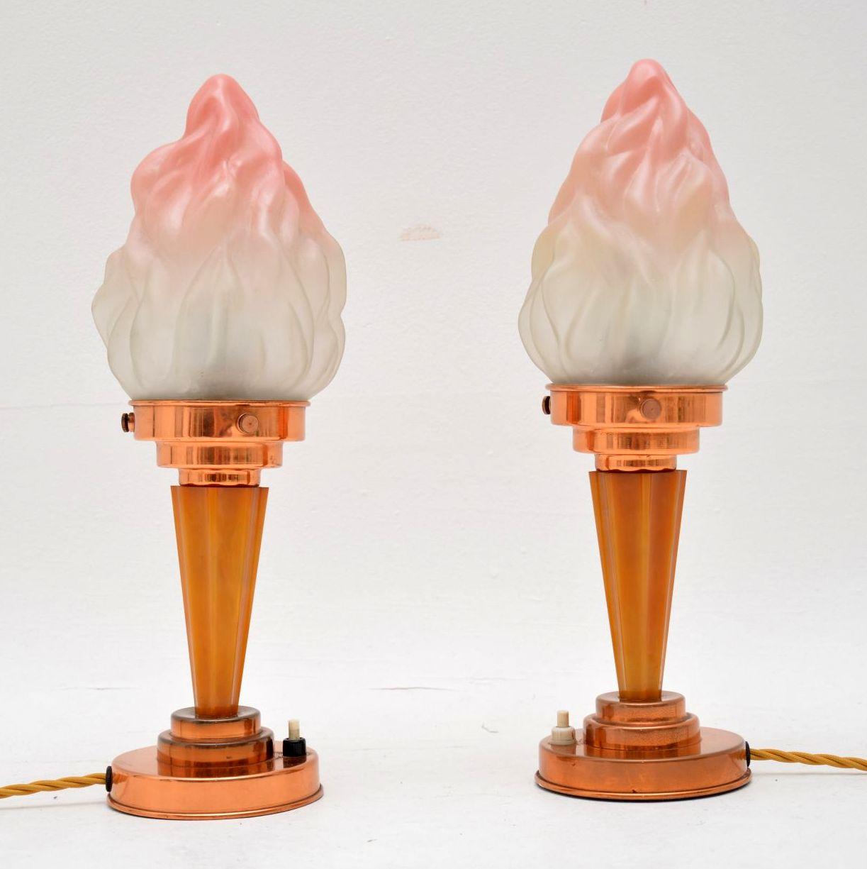 A stunning and rare pair of original Art Deco period table lamps with beautiful glass shades and Bakelite bases. They date from the 1930’s, and are in superb original condition. The coloured glass shades have no chips or cracks, they have both been