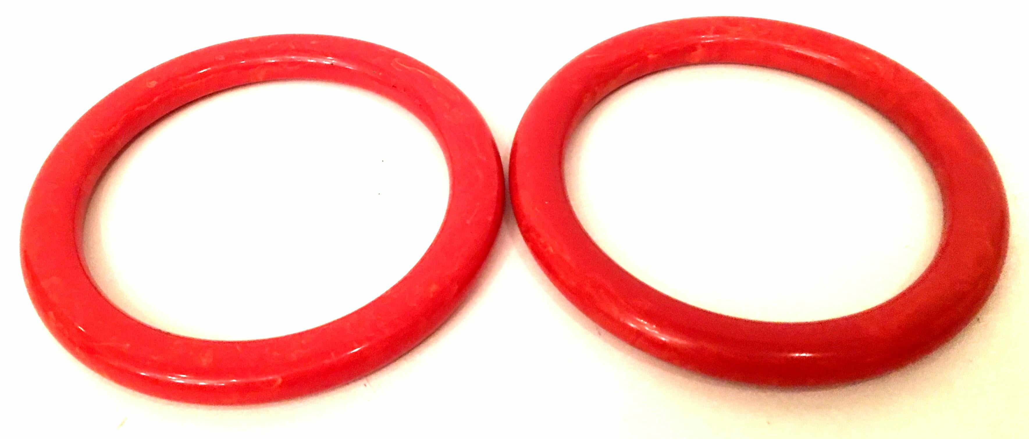 1930'S Pair of Bakelite rounded edge marbleized tomato red bangle bracelets. These tubular bangle bracelets feature jeweled gold infusion Internal diameter measures, 2.5