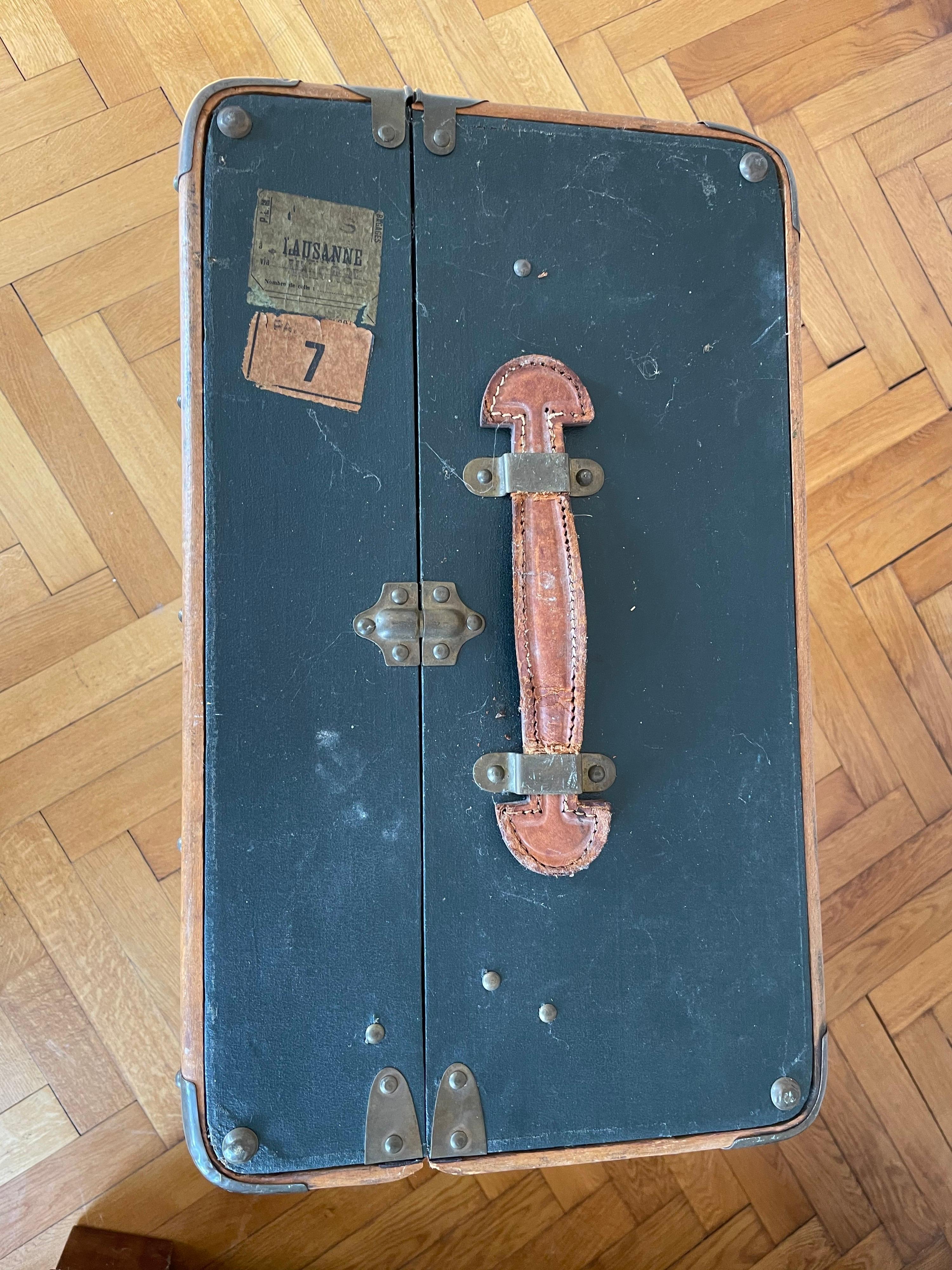 Large authentic suitcase with the original labels. Right leather hand is missing. Overall stabile condition.