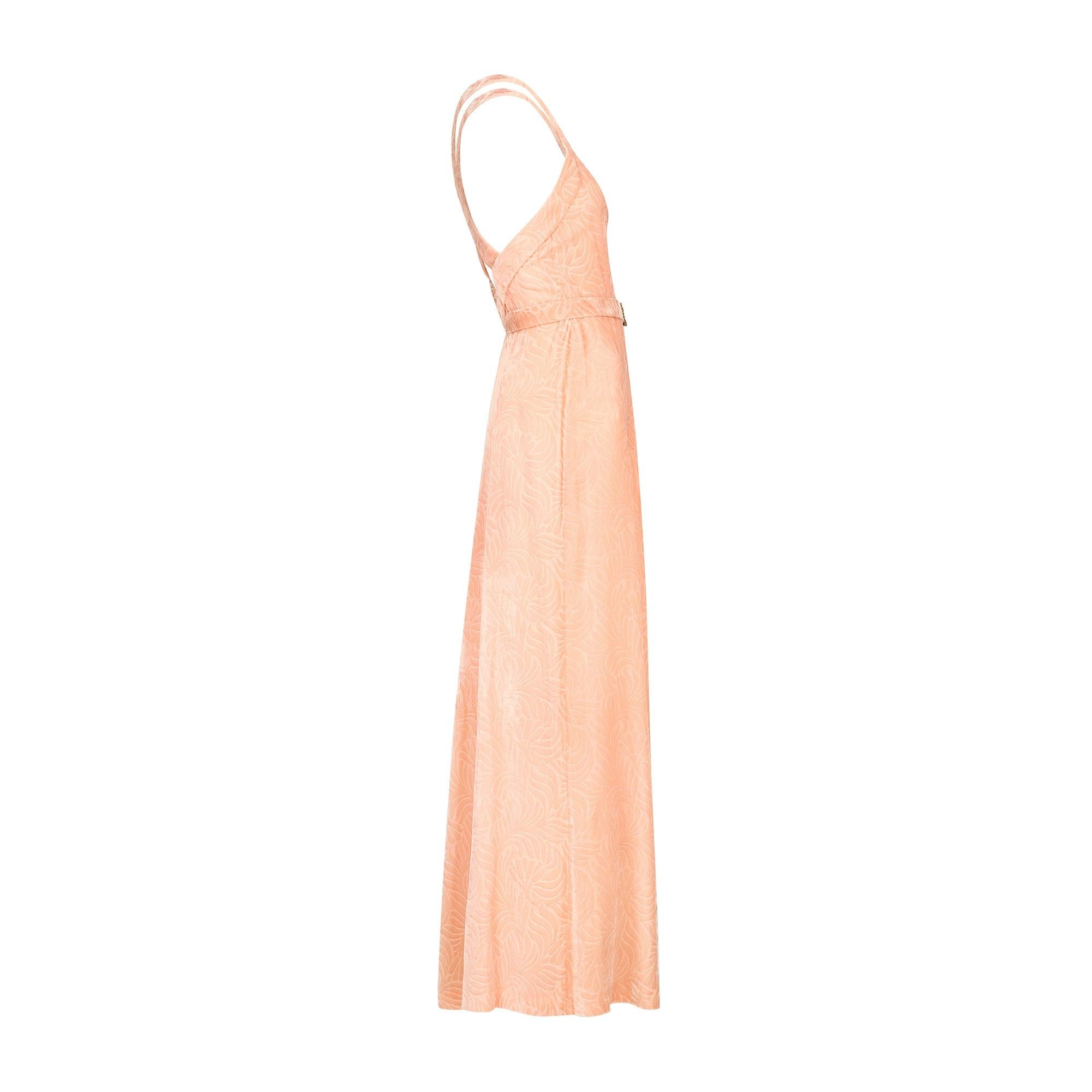 An enchanting 1930s evening dress tailored to a timeless silhouette; the pale pink velvet textured and patterned with petals and leaves. The dress features a relaxed, column style body and full-length, floor-sweeping skirt. The bust is fitted and