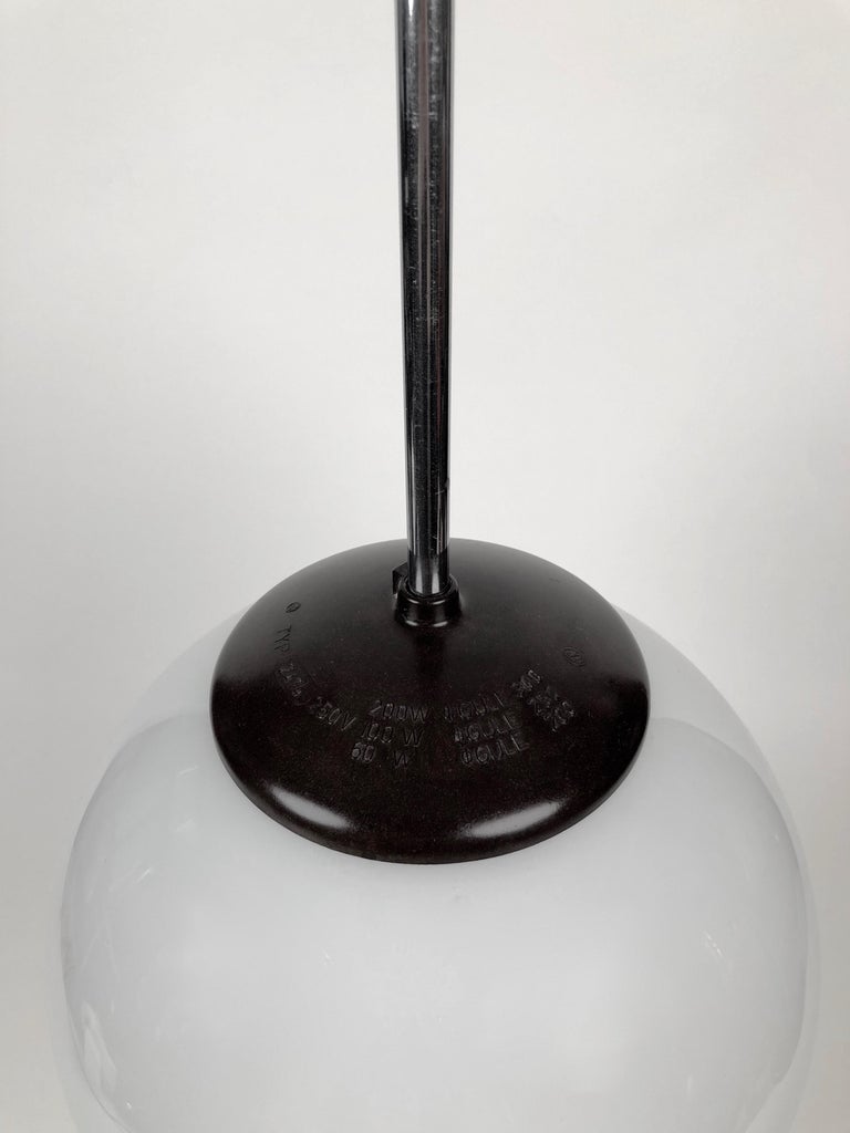 Classic 1930s pendant lamp with round opaline glass globe. The design has Bauhaus influences. The Bakelite is in very good condition.