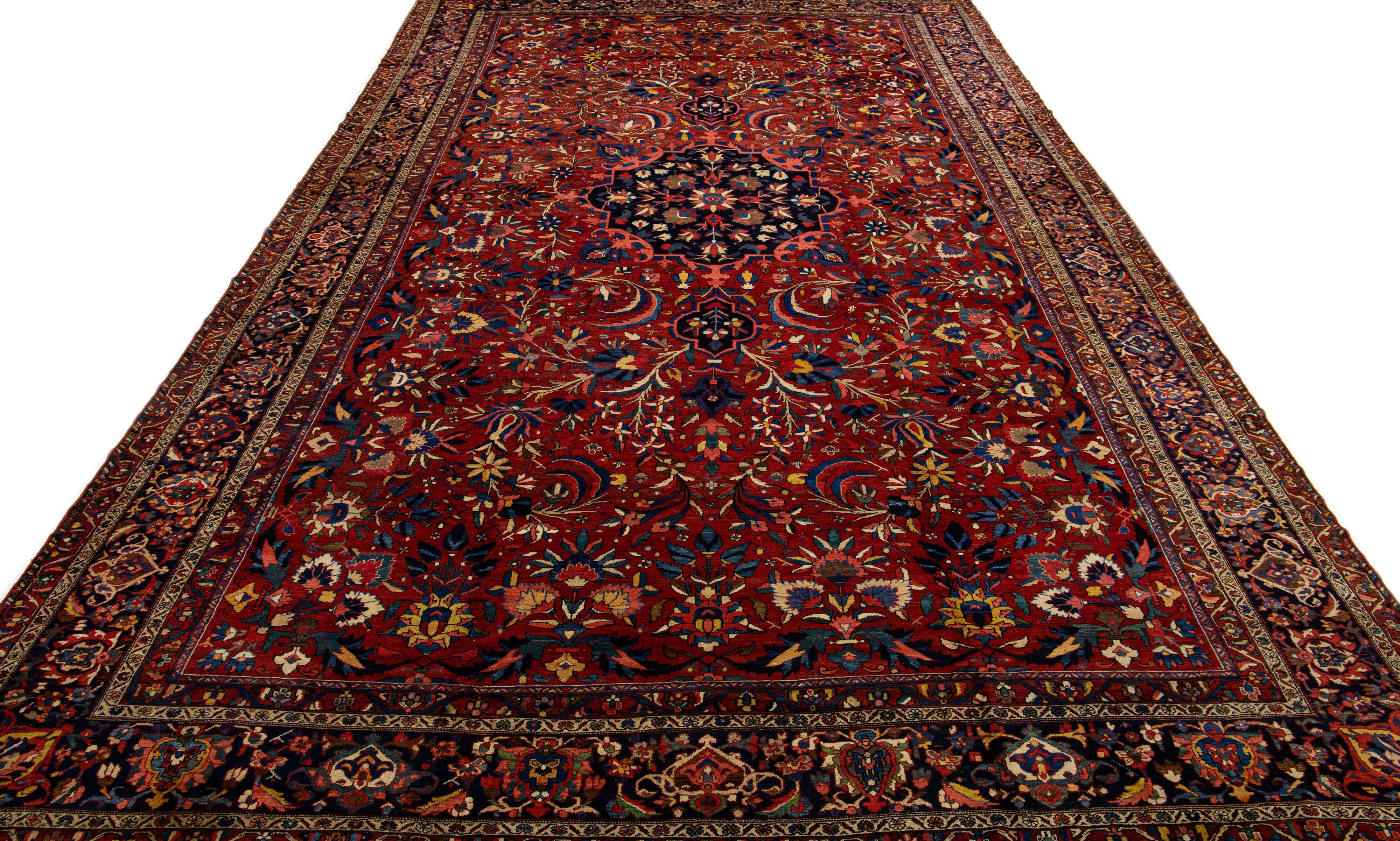 Crafted with precision and meticulous detail, this Bakhtiari hand-knotted wool rug showcases a Classic tribal design set against a red-colored field, highlighted by vibrant and colorful accents.

This rug measures 14'3
