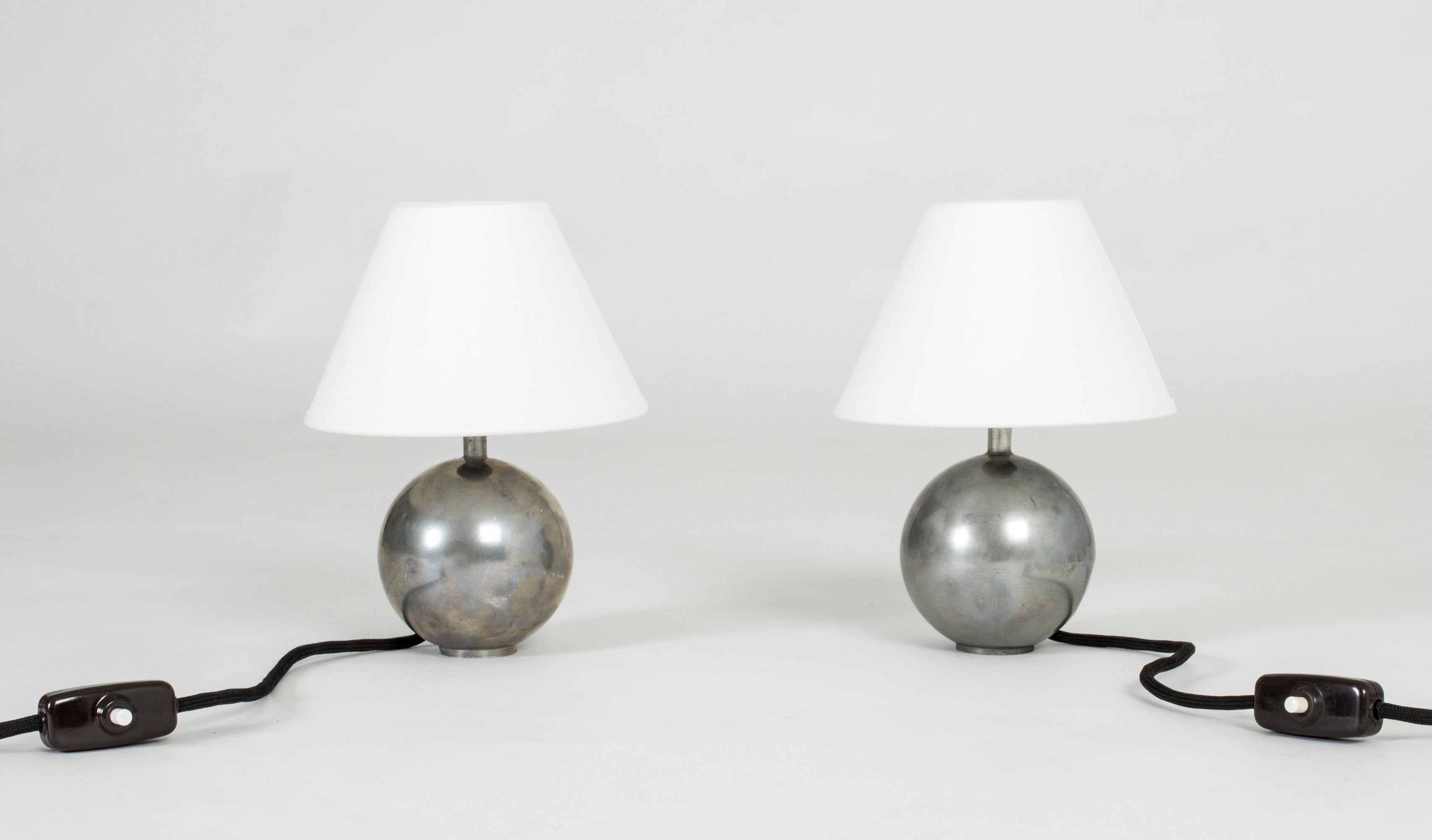 Pair of rare pewter table lamps by Björn Trädgårdh. Elegant design with neat globe-shaped bases.