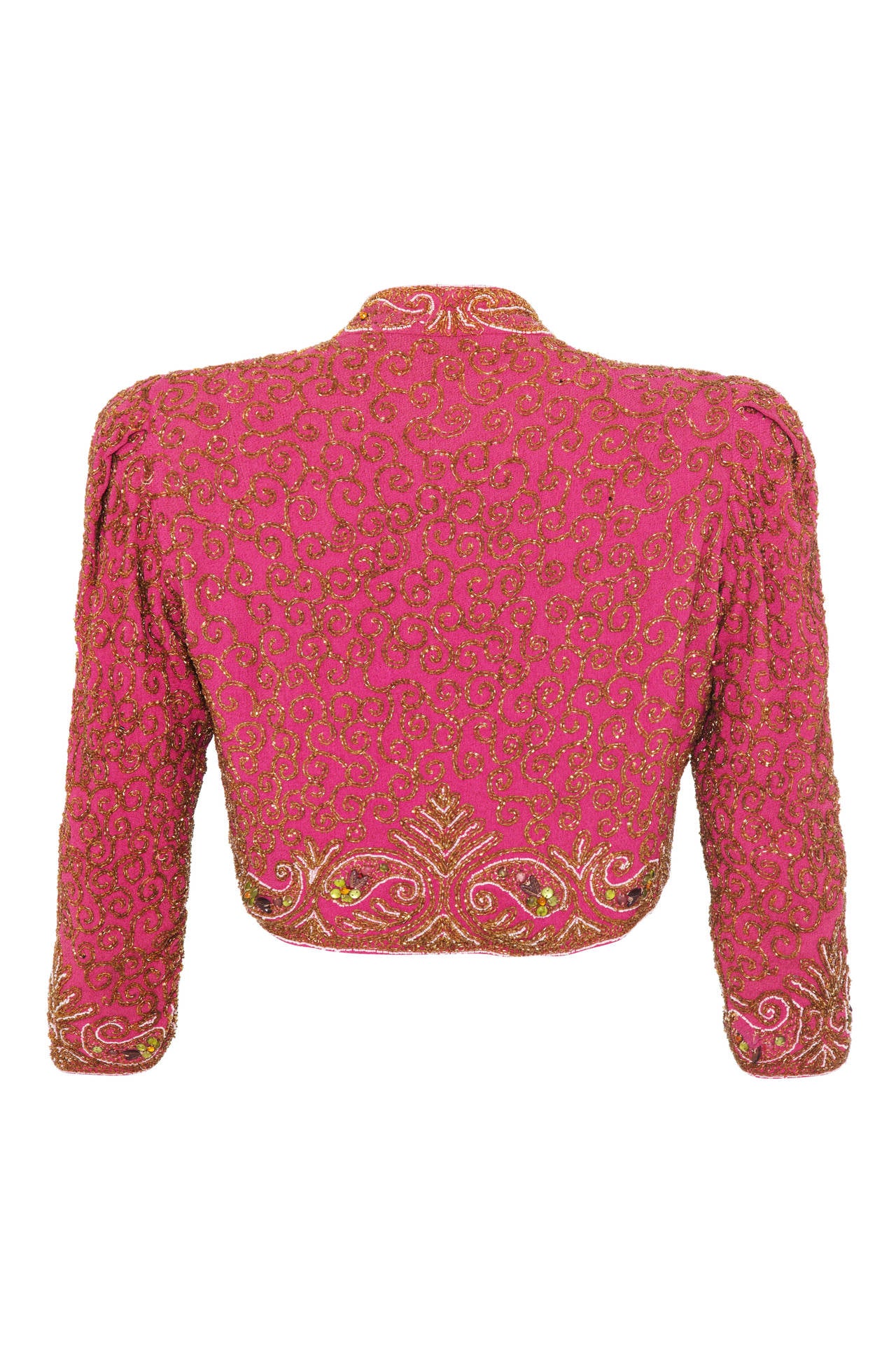 Exquisite pink silk bolero jacket from the late 1930s/ early 1940s with intricate gold beading throughout.  This piece has hook and eyes to fasten at the front and is in excellent condition for something of this age with no missing beads.  It has