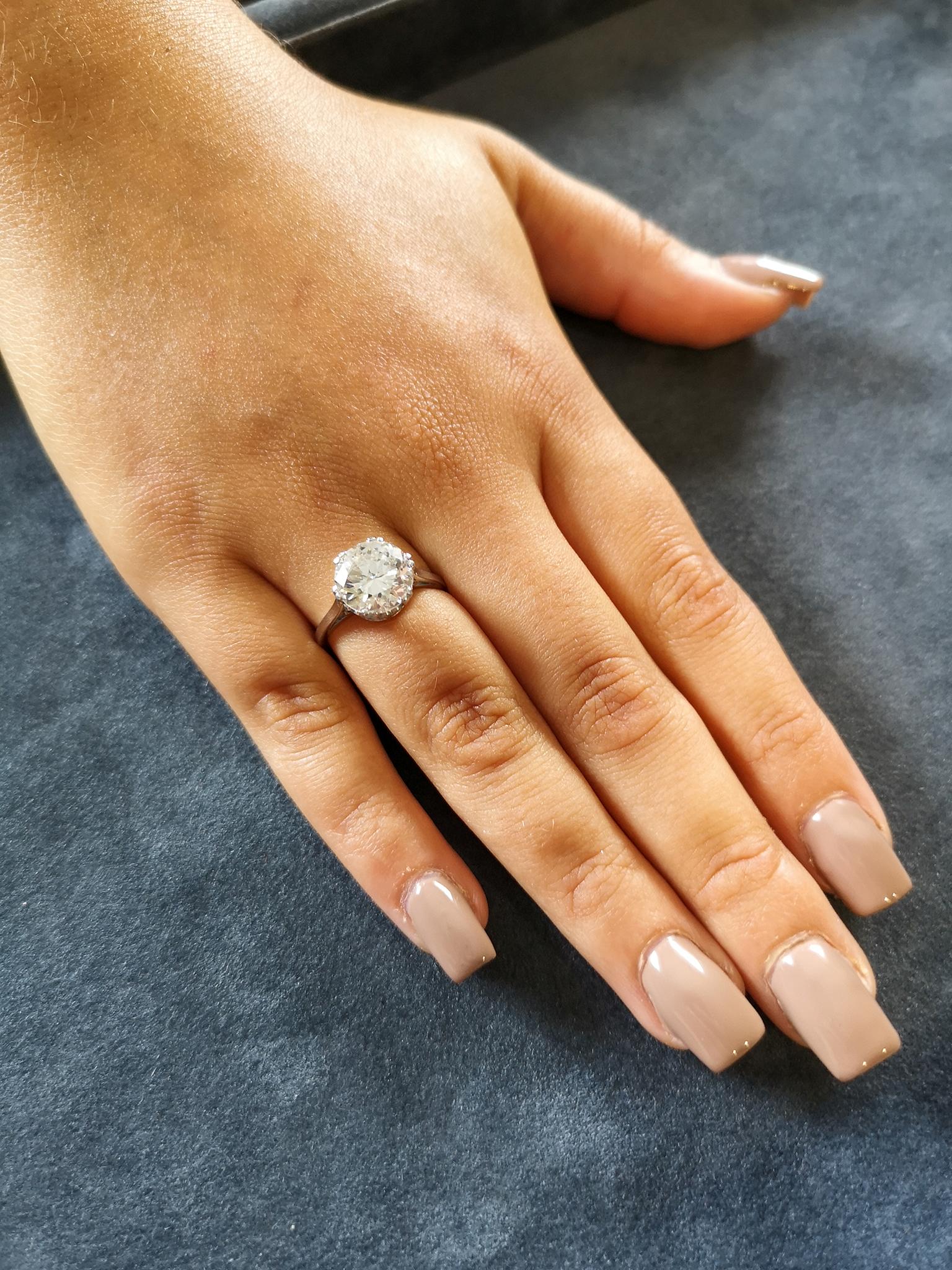  A fine, bright and lively 'transition' brilliant cut solitaire diamond mounted in a traditional basket setting with six double claws  Diamond Weight: Approximately 3.29 carats  Colour: G  Clarity: SI2  Setting: Uniform, polished, squared 18-carat