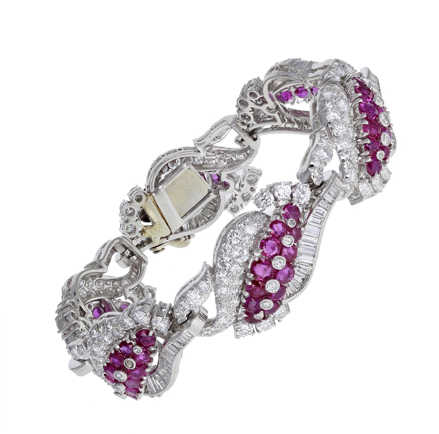 An exquisite 1930s diamond and Burma ruby bracelet in platinum. Comprising curved, pierced sections, mounted with claw-set, brilliant-cut blood-red Burma rubies and brilliant and baguette-cut diamonds. 18-carat white gold clasp. A particularly fine