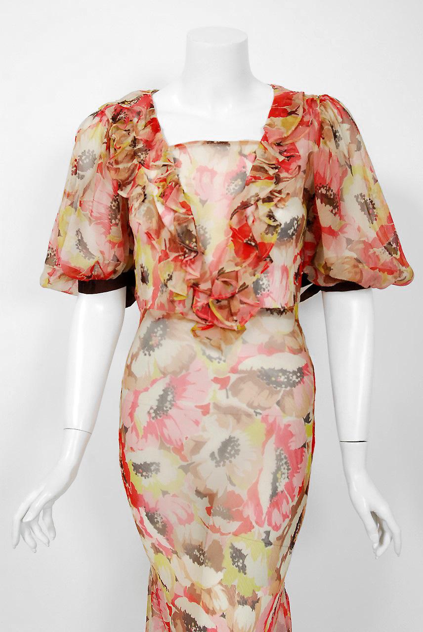 The breathtaking large-scale poppies floral garden print used on this 1930's semi-sheer silk chiffon gown has a fresh innocence that I find irresistible. The bodice has an elegant front ruffle and voluminous bow-trimmed sleeves. The nipped waist