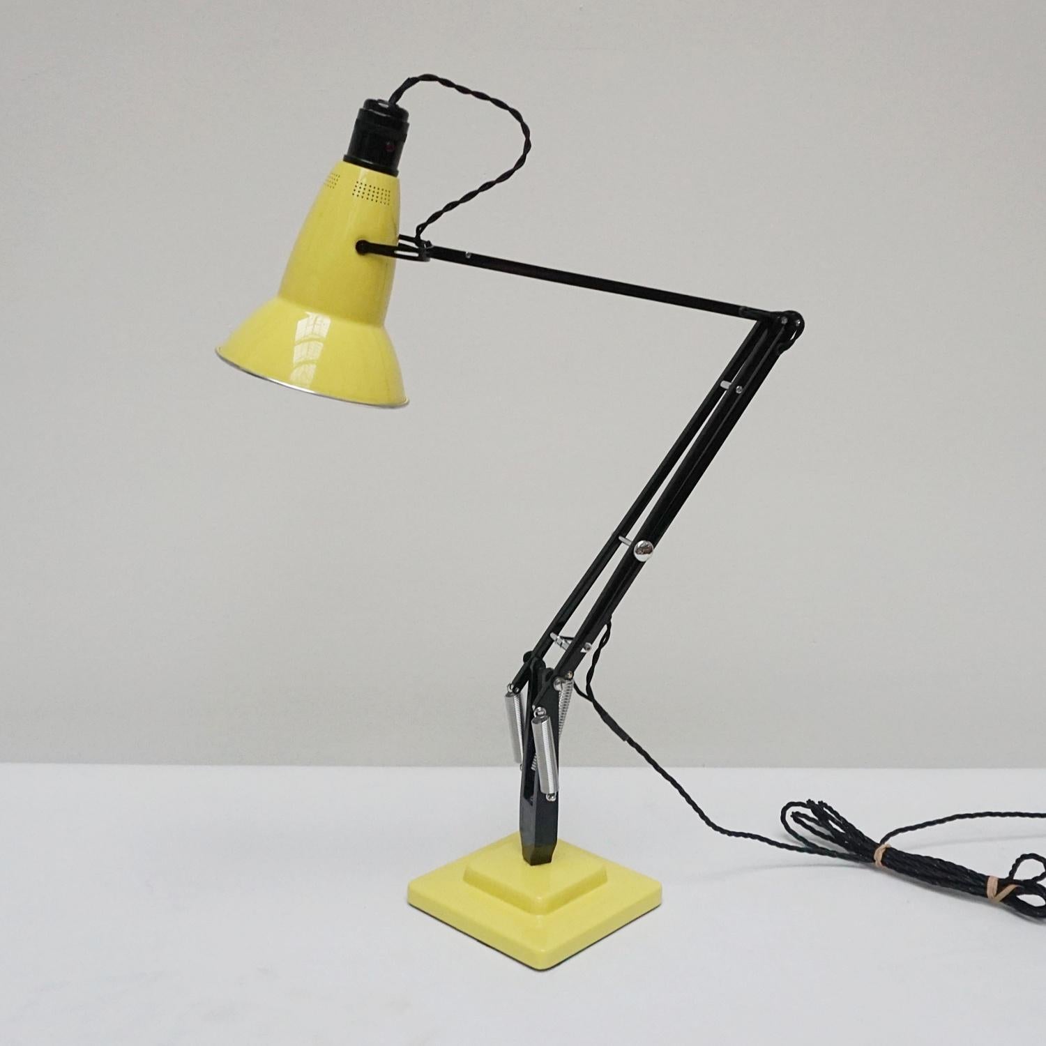'Three-spring' 1930's prototype Anglepoise desk lamp by Herbert Terry & Sons. Black arm assembly with matching yellow two step base and perforated lamp shade. Original stamps to stem. The three spring Anglepoise lamp was first released by Herbert