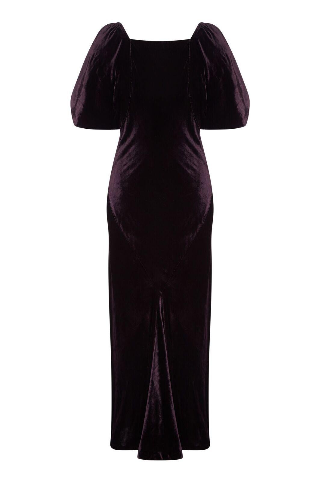 This enchanting 1930s deep purple velvet evening gown is in superb condition and exudes the glamour of the era. The rich velvet fabric is a deep aubergine shade and is skilfully cut on the bias to flatter an hourglass figure, drawing in snugly at