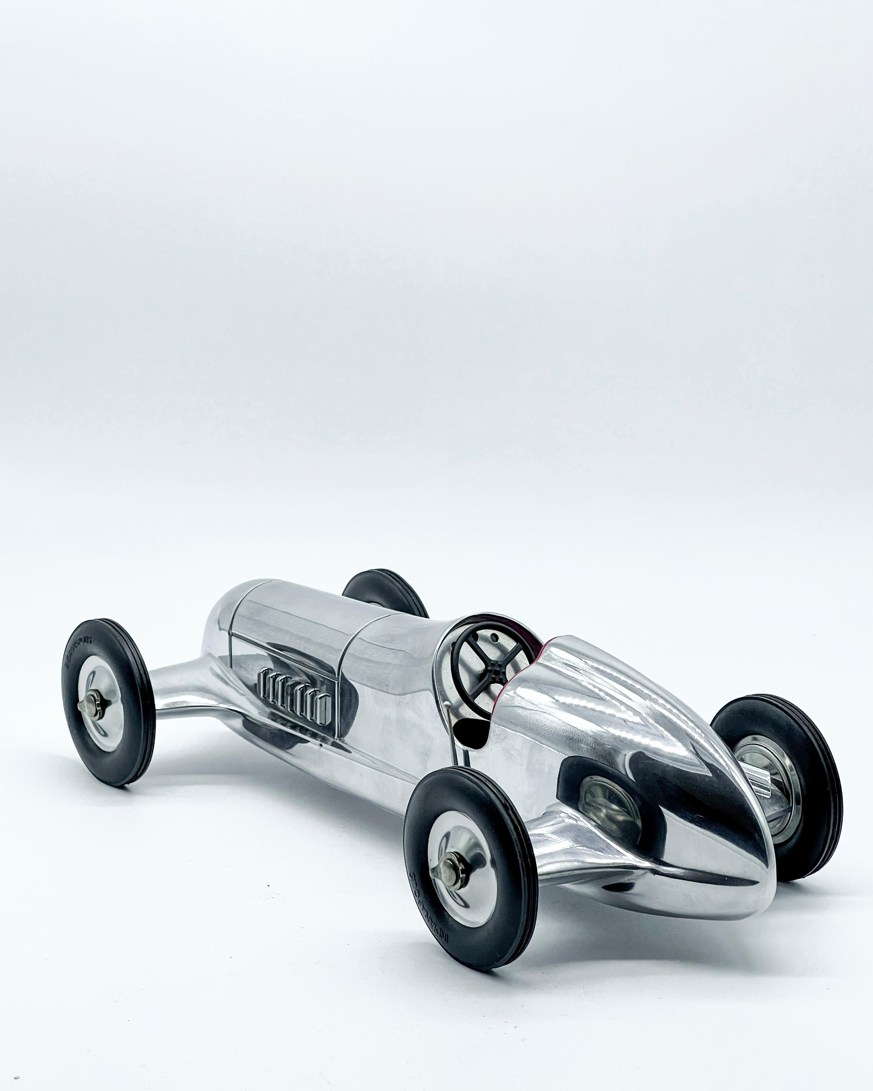 Stunning contemporary reproduction of a vintage racing car from the 1930s. The streamlined body, exhaust pipes, wheels and dashboard are all faithfully reproduced and highly detailed.

With a length of thirty centimeters, the model is a stunning