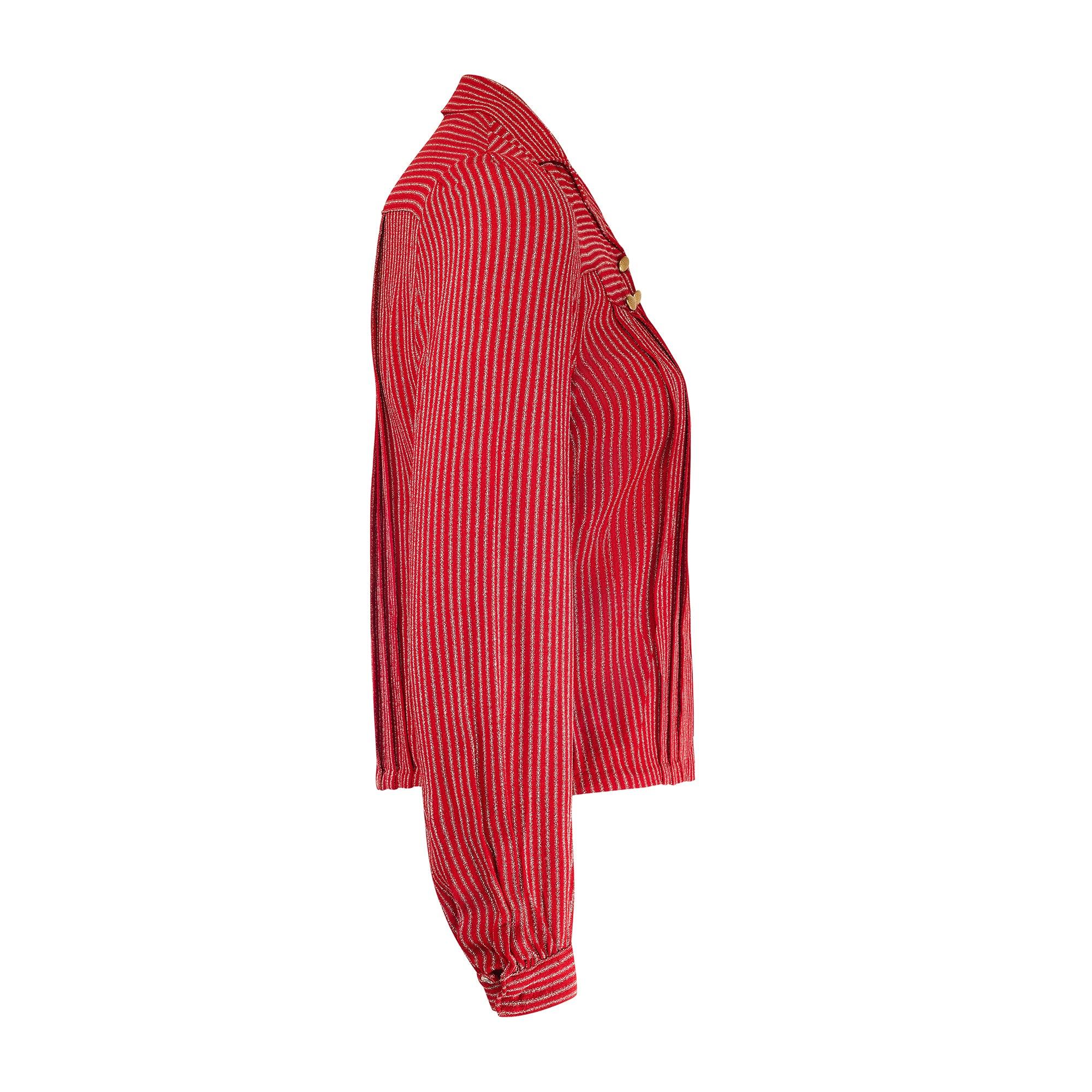 This red striped crepe blouse is an extremely wearable piece of antique clothing dating from the late 1930s. It is made from a thick, textured red crepe detailed with a fine white stripe with tiny aqua stitches either side of each stripe. The shirt