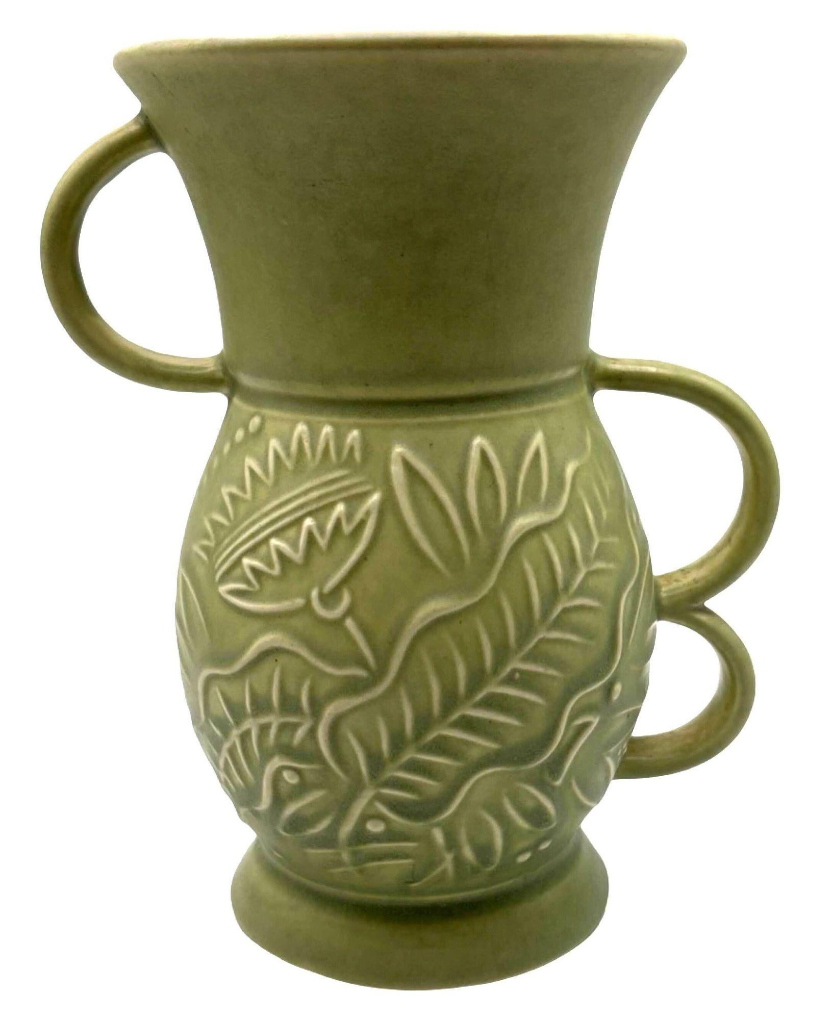 This 1930s vintage Red Wing Art Deco vase showcases timeless elegance with its striking three-handle design. Crafted in pottery, its vibrant glaze enhances the intricate floral details that dance across the surface. The Art Deco influence is evident