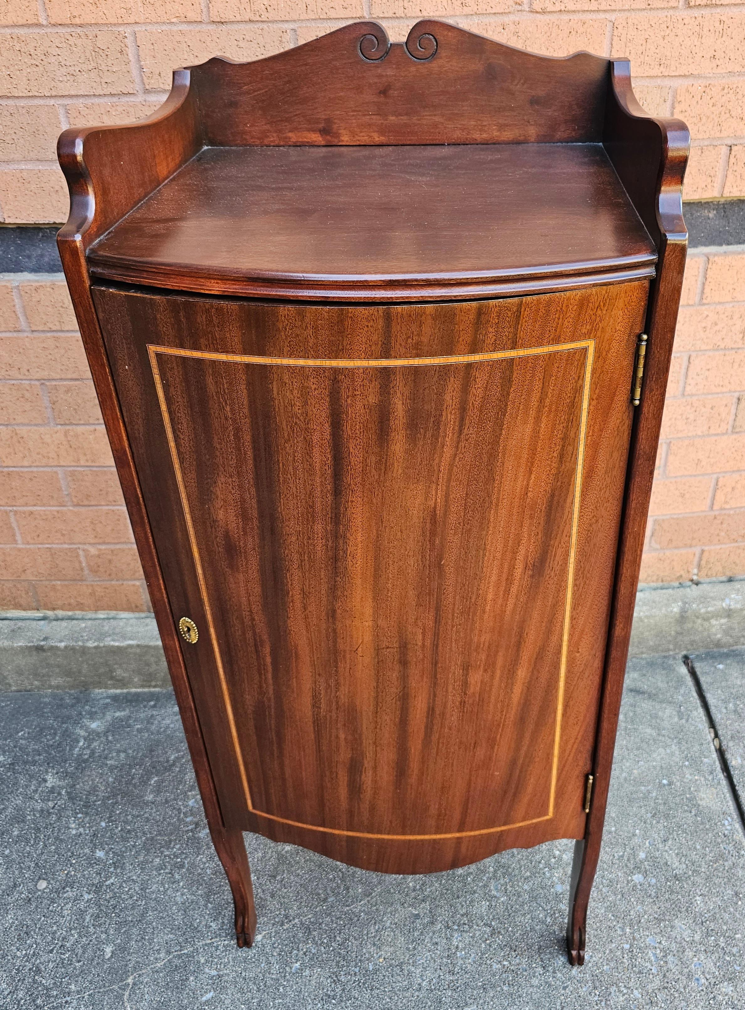 1930s Refinished Edwardian Mahogany and Satinwood Inlaid Sheet Music Cabinet. Comes with two adjustable height shelves. Unsed in mrdern days as side cabinet for various purposes.
Totally refinished and in great antique condition. Measures 18