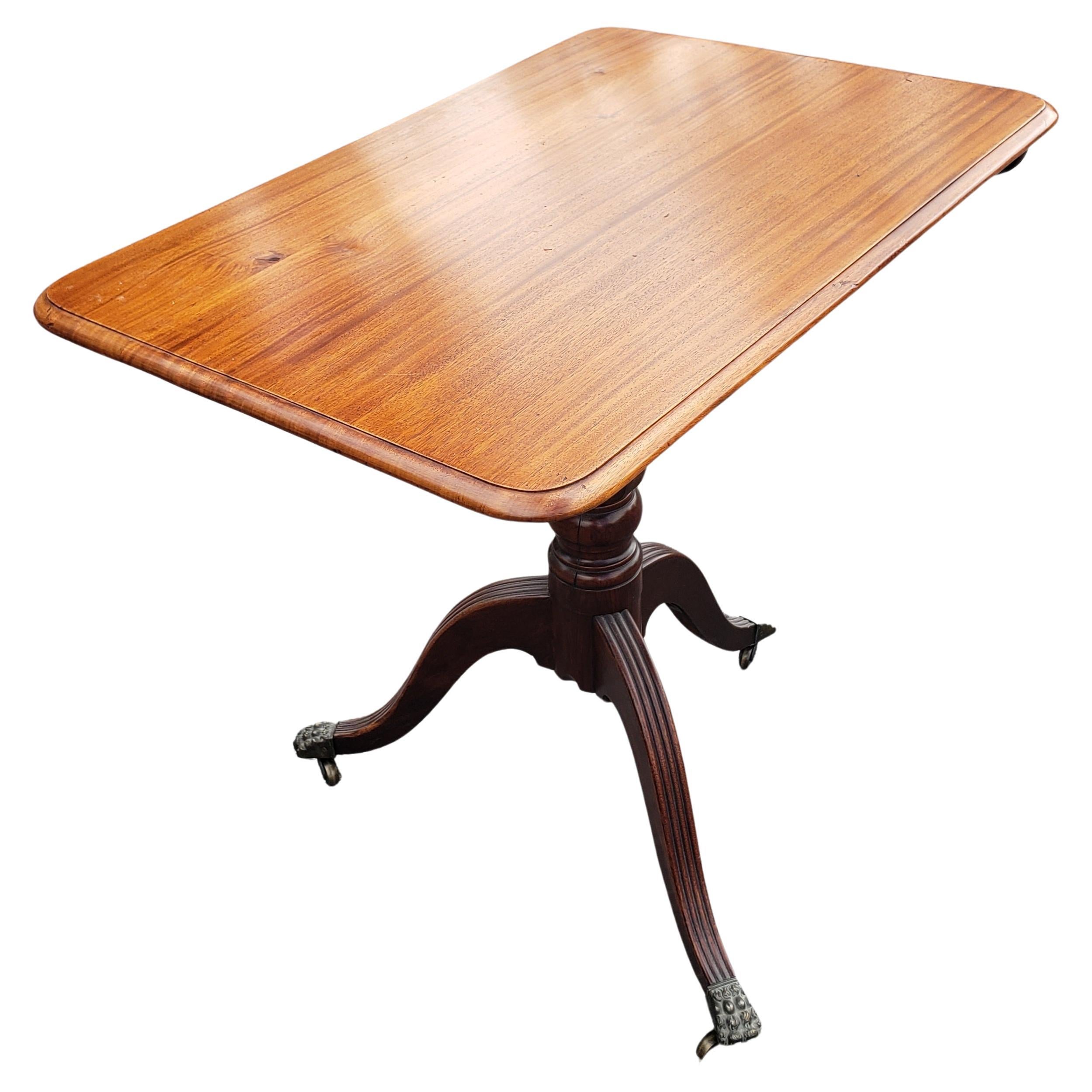 1930s Regency Mahogany Tilt-Top Tea Table with Brass Paw Feet on Wheels In Good Condition For Sale In Germantown, MD