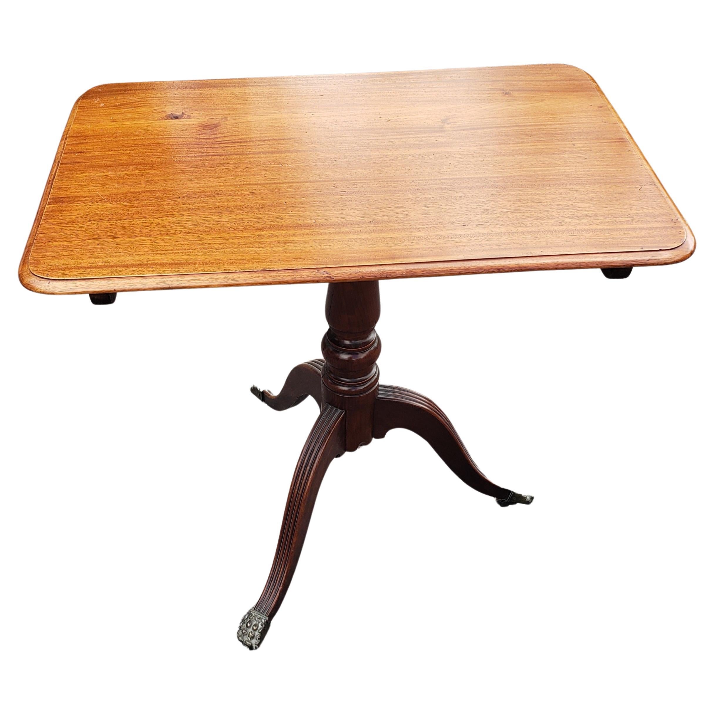20th Century 1930s Regency Mahogany Tilt-Top Tea Table with Brass Paw Feet on Wheels For Sale