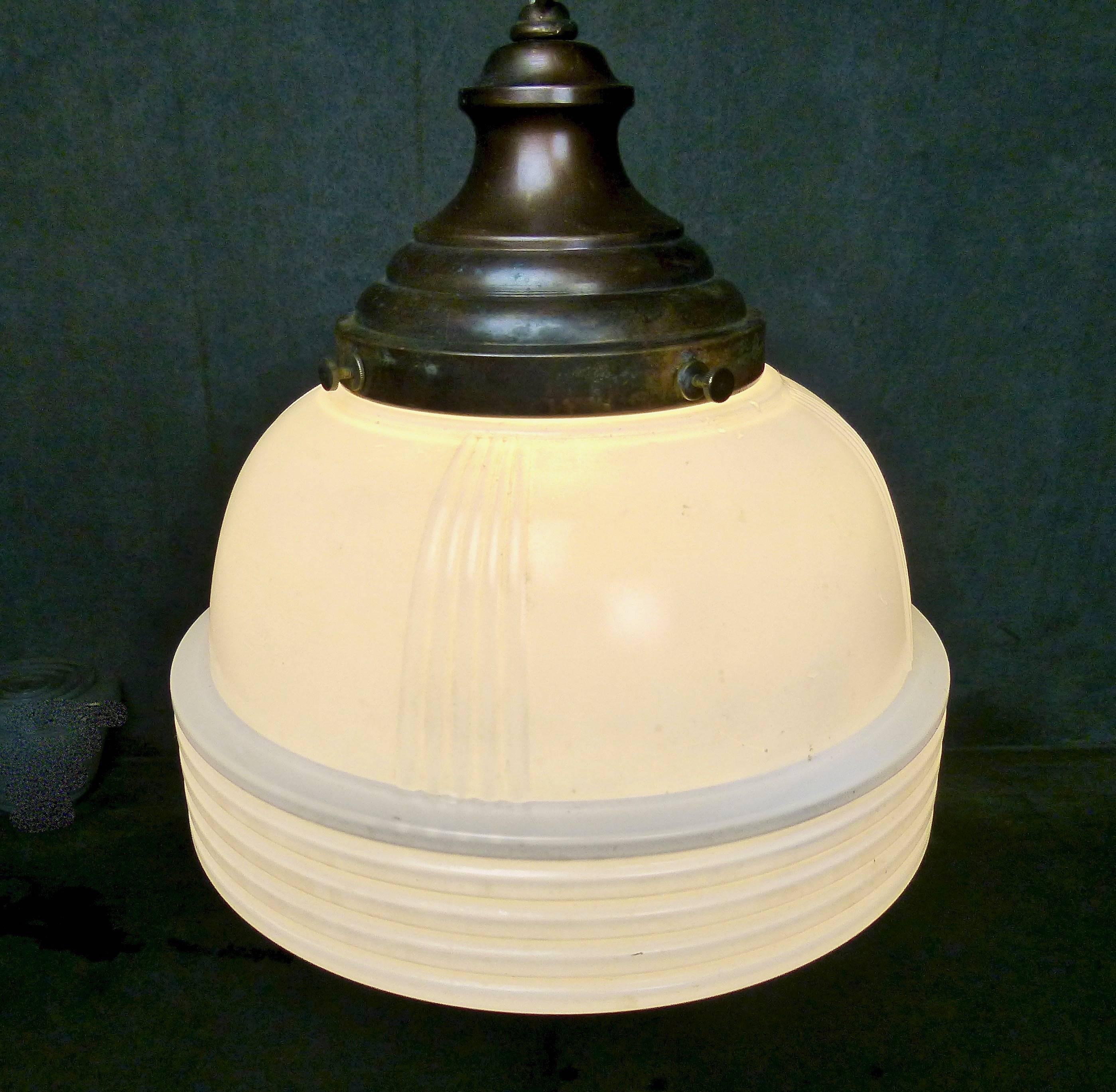 Authentic 1930s pendant lights that attractively contrast ribbed milk glass and clear glass design elements. Currently five in stock. Re-wired and CSA approved; ceiling mount included. Example of mount in photo is representative; we offer a variety