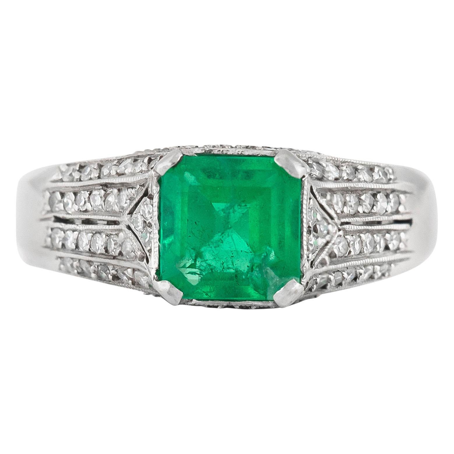 1930s Ring with Center Emerald and Round Diamonds on the Side Ring For Sale