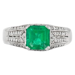 Vintage 1930s Ring with Center Emerald and Round Diamonds on the Side Ring